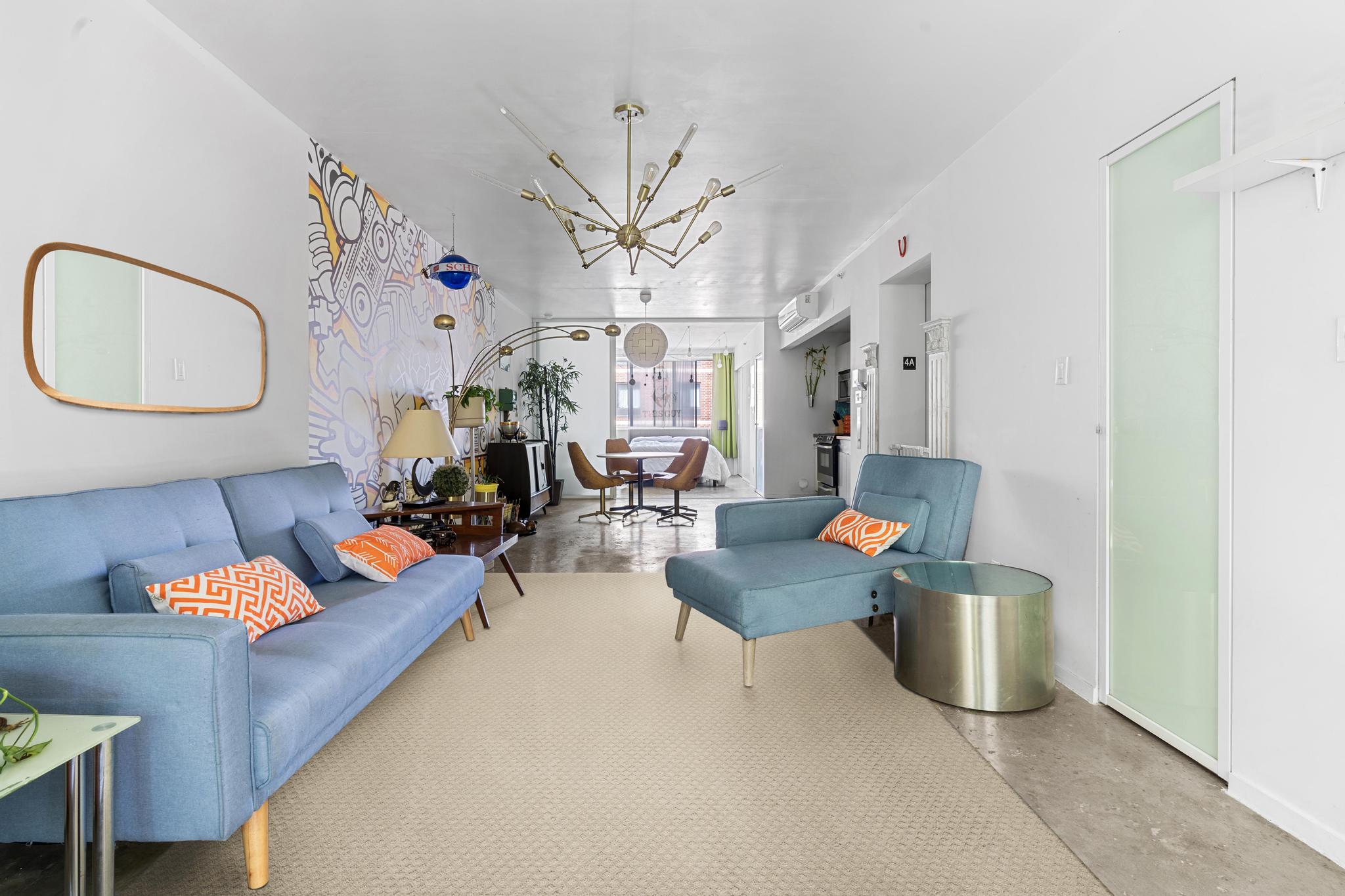 a living room with furniture and wooden floor