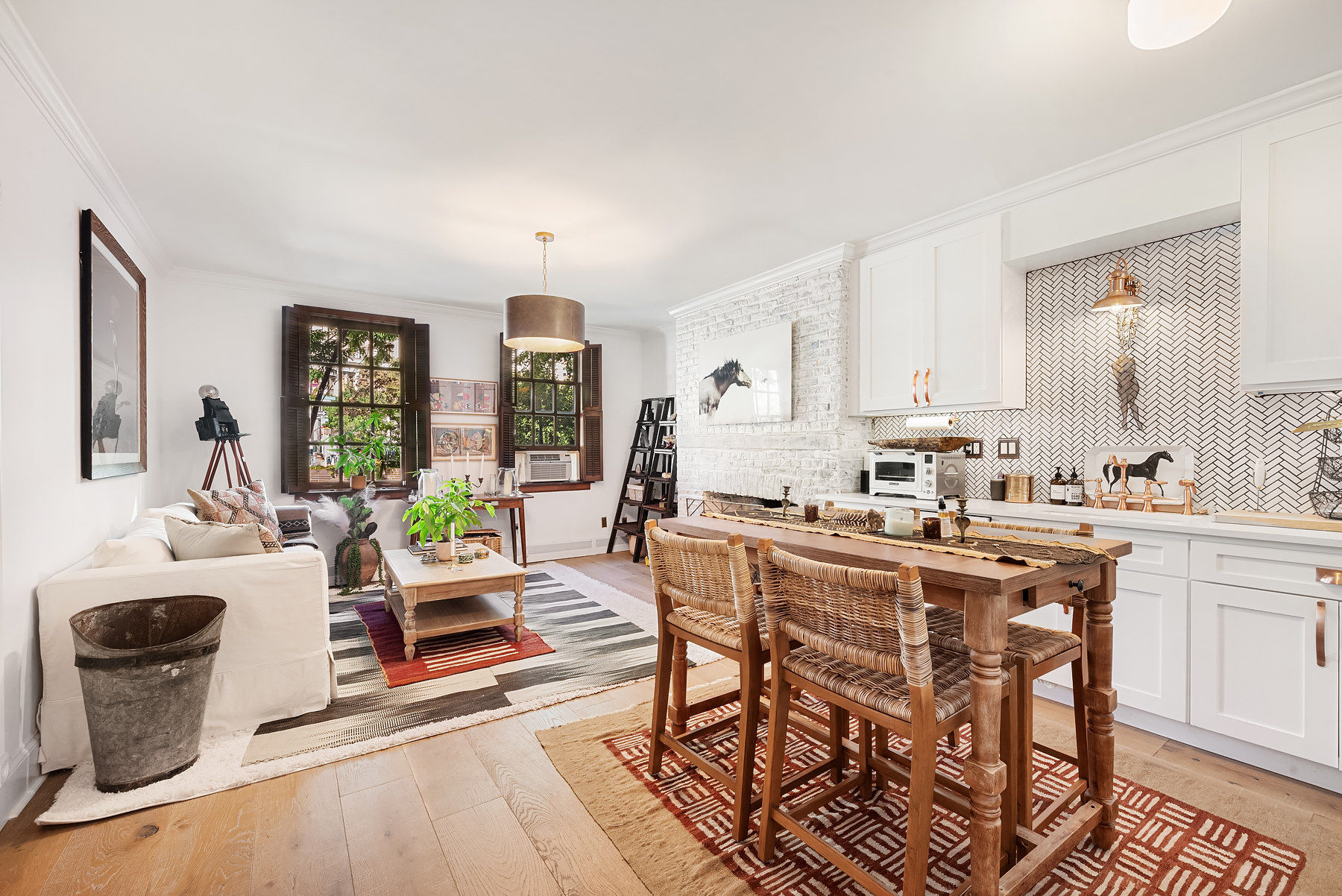 a kitchen with a dining table chairs and white cabinets