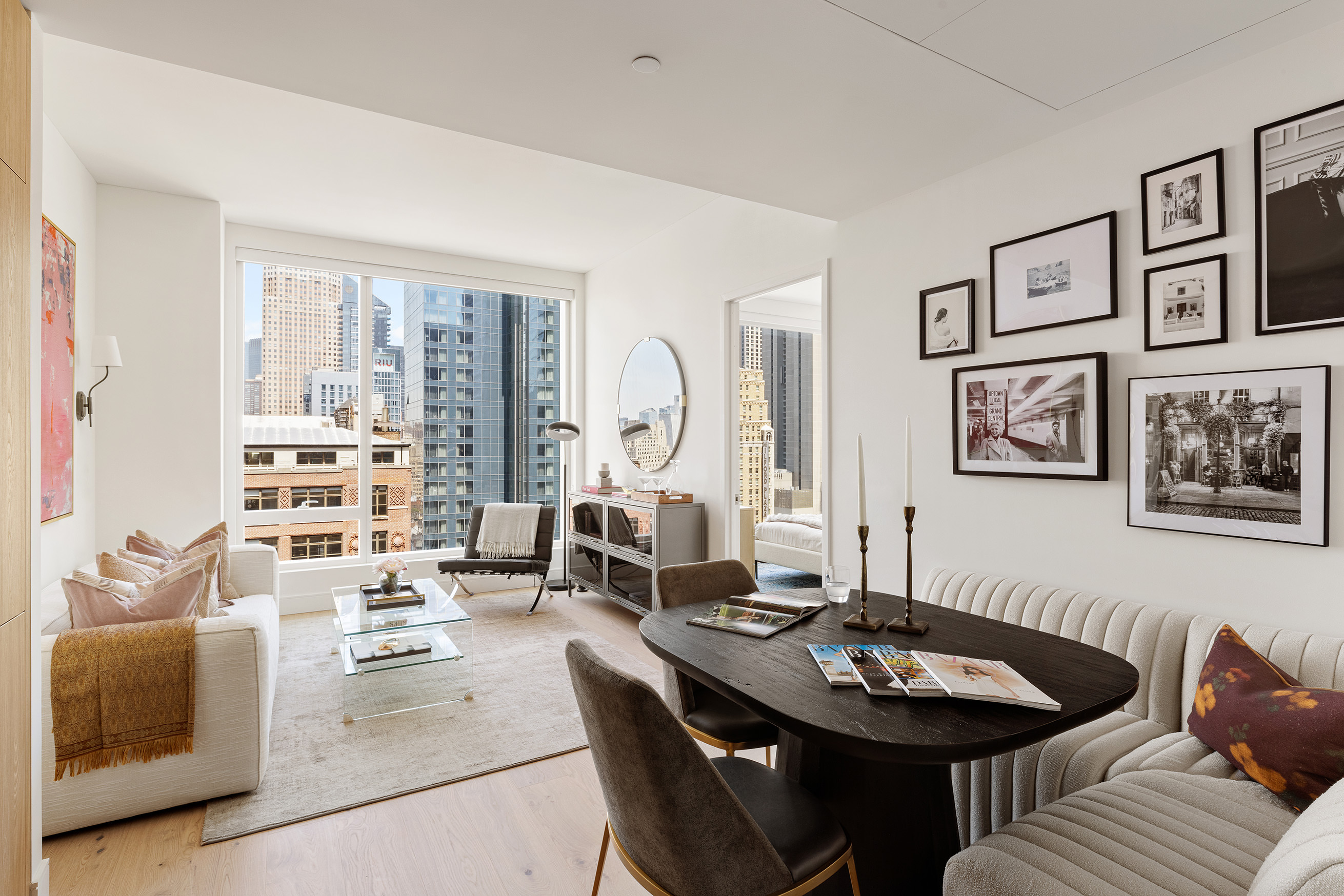 a living room with furniture a table and a large window