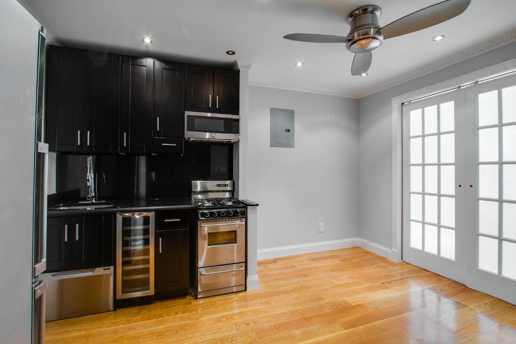 a view of kitchen with microwave and cabinets