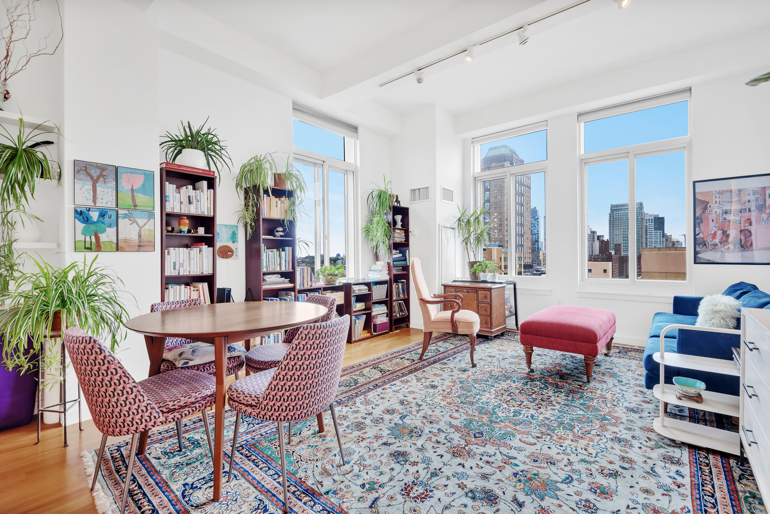 a living room with furniture a rug and a potted plant