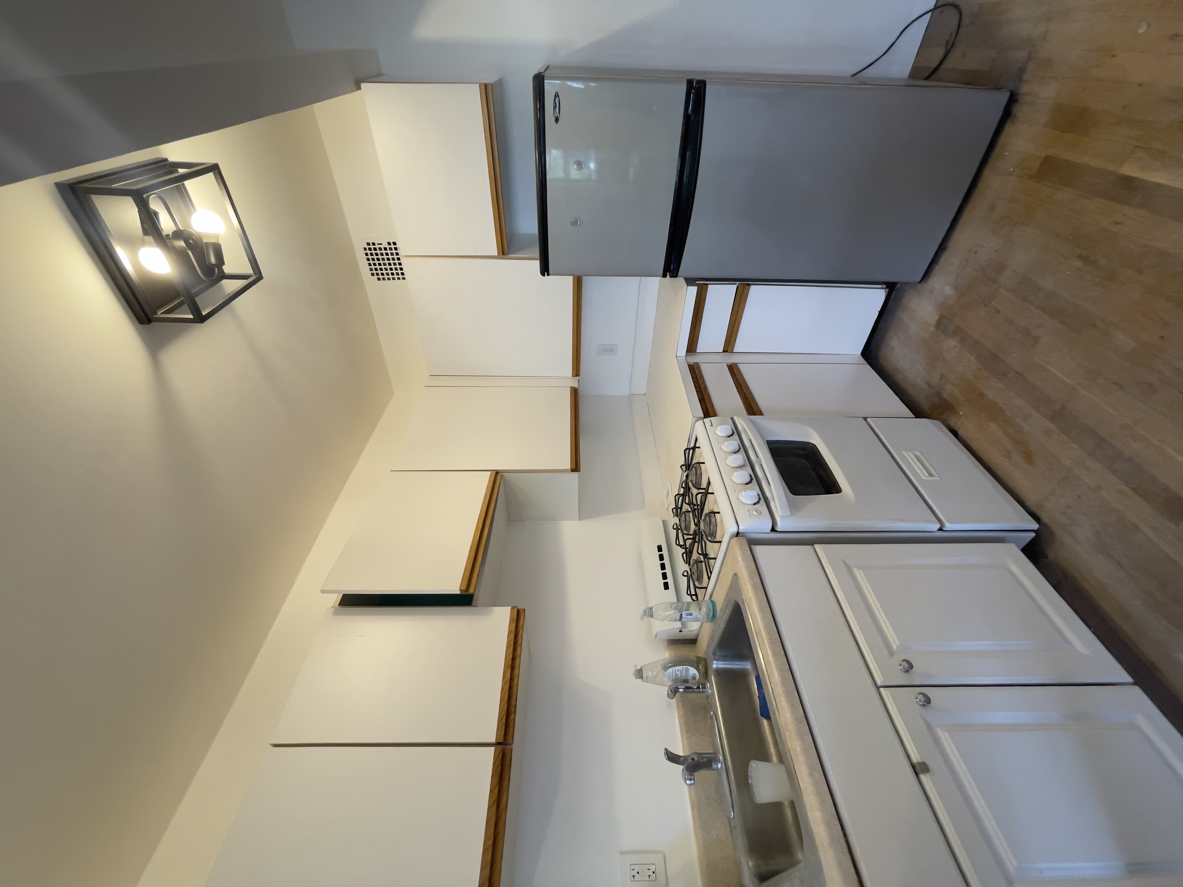 a kitchen with cabinets appliances and a sink