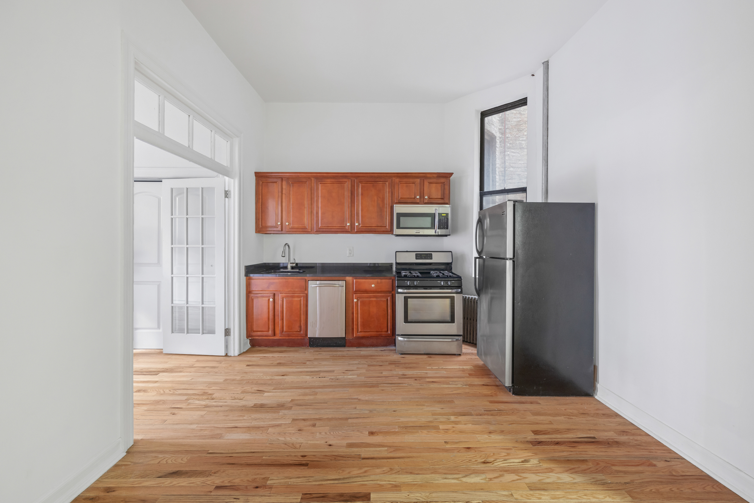 a kitchen with stainless steel appliances a refrigerator and a stove top oven