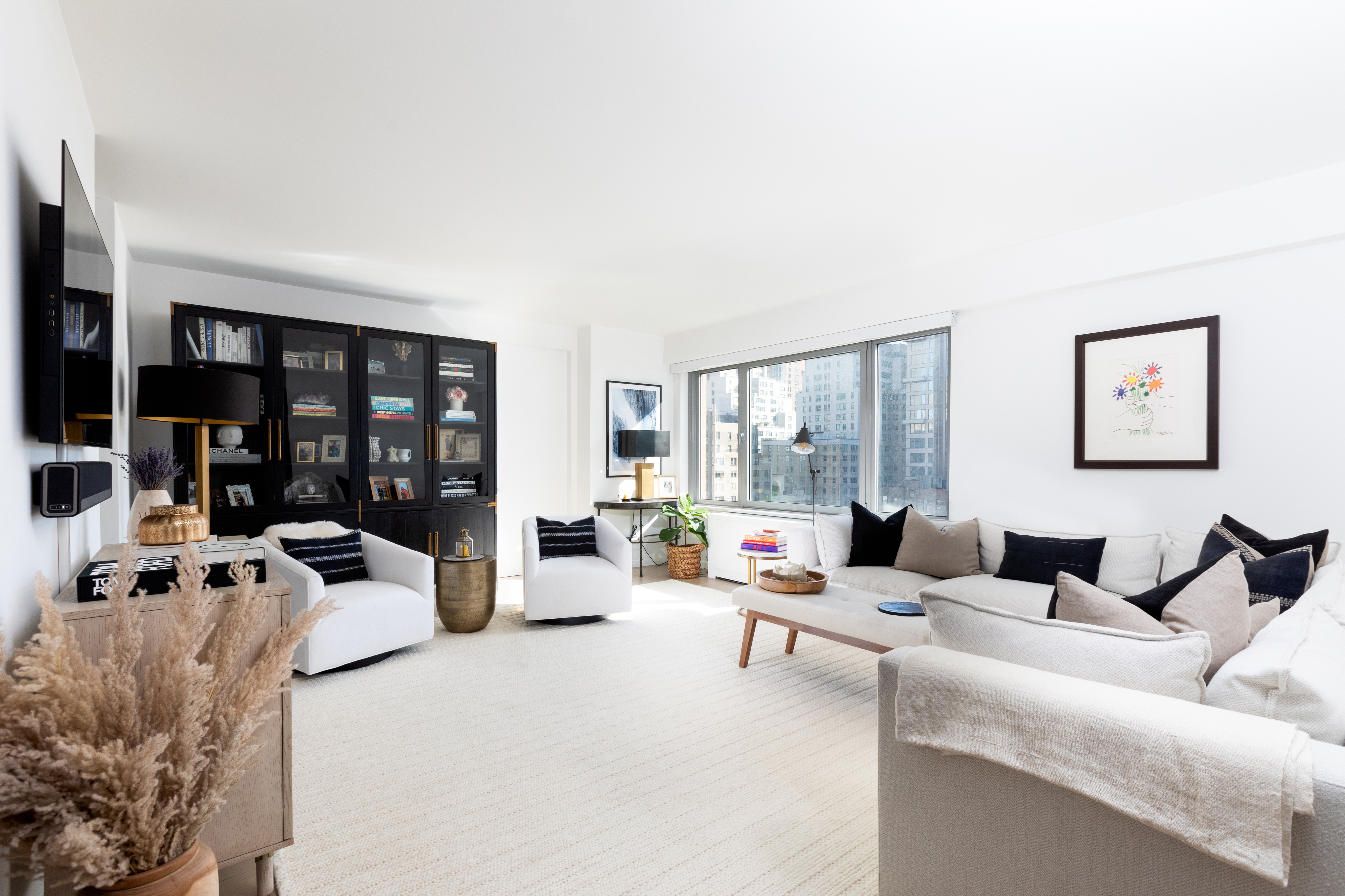 a living room with furniture and large window