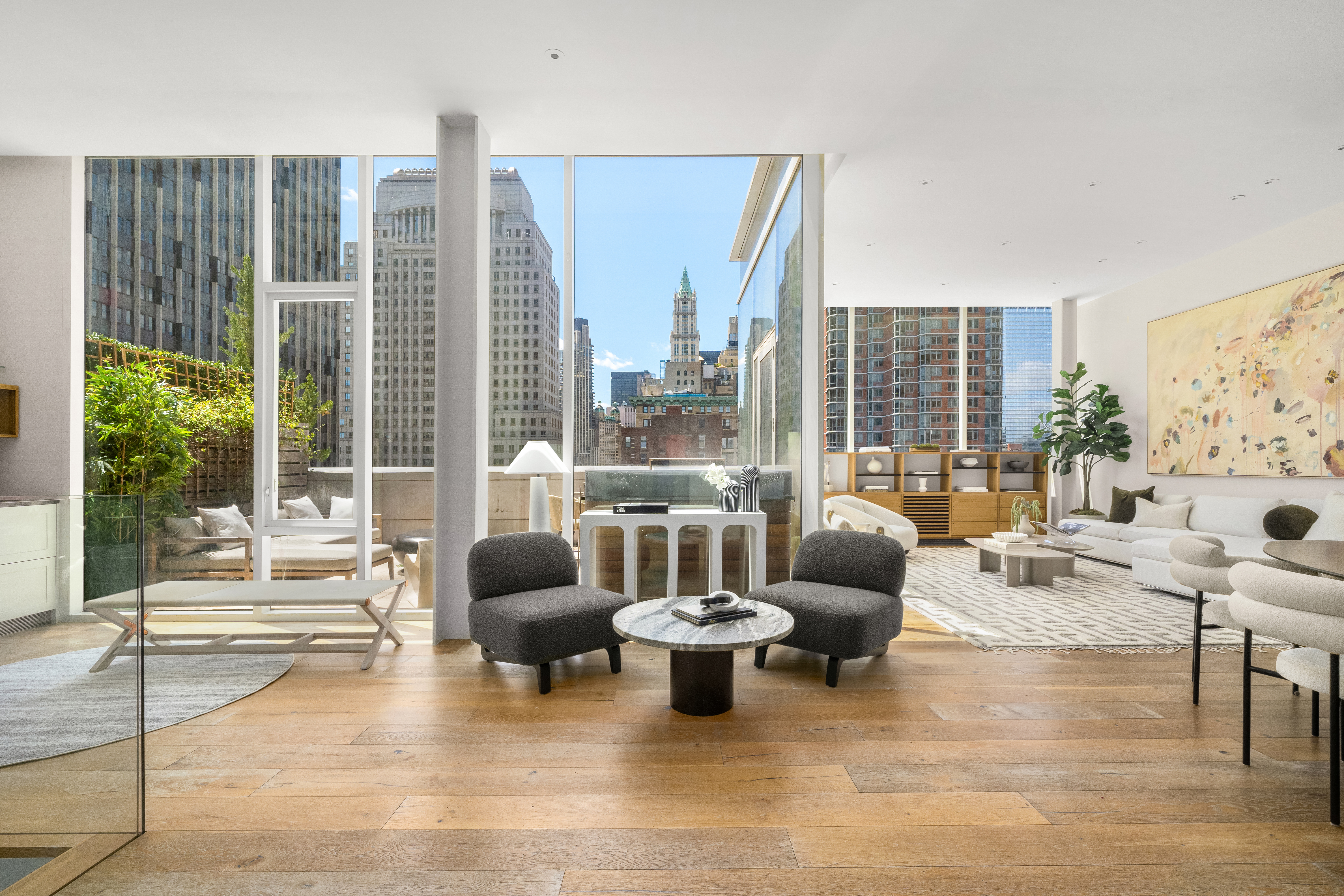 a living room with furniture and floor to ceiling windows