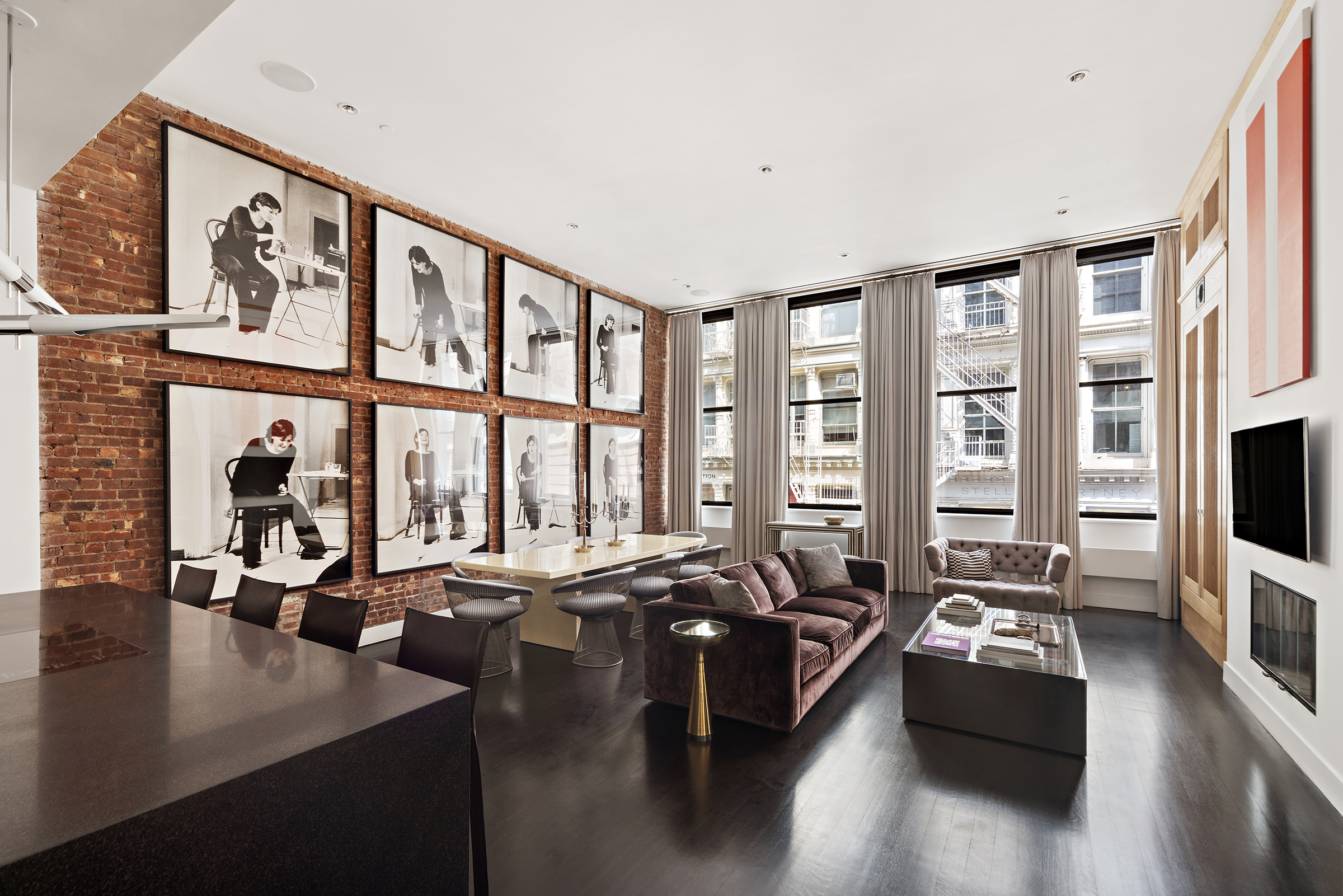 a living room with furniture large window and a flat screen tv