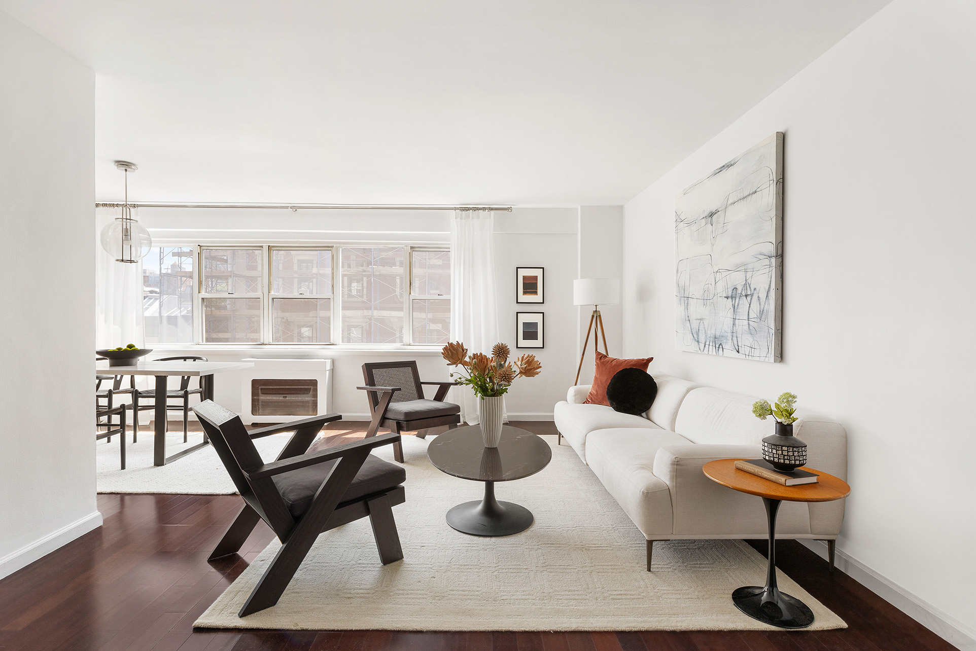 a living room with furniture a table and chair with wooden floor