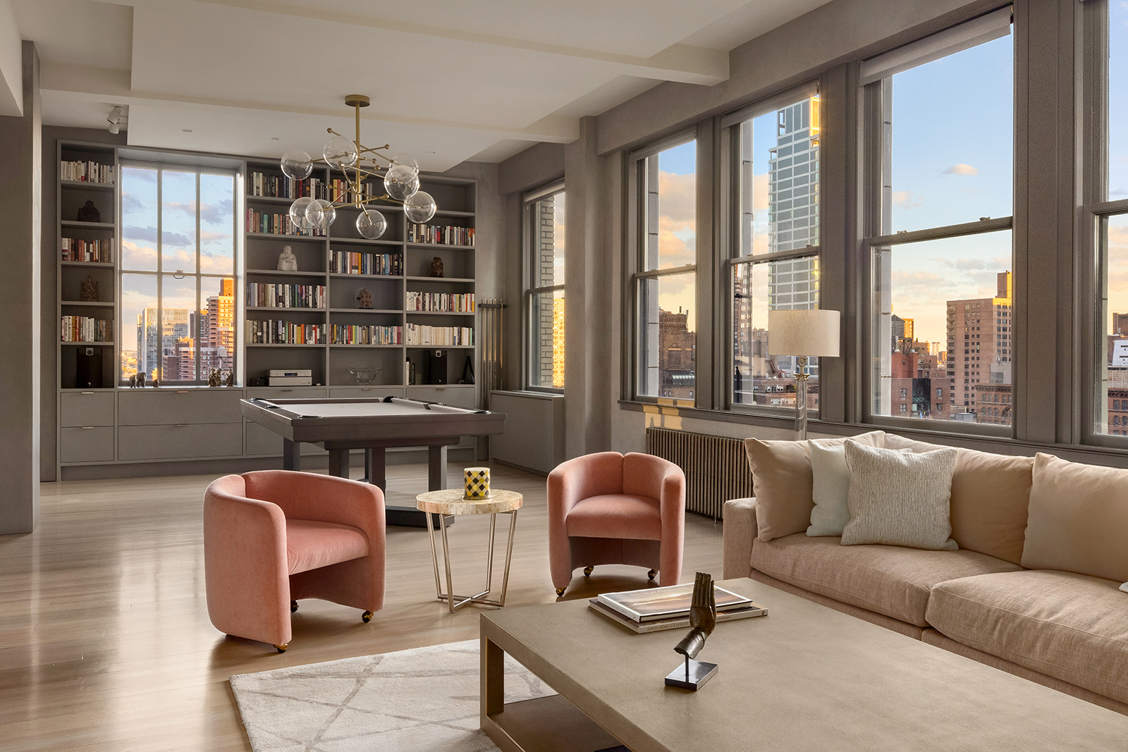 a living room with furniture a chandelier and large window