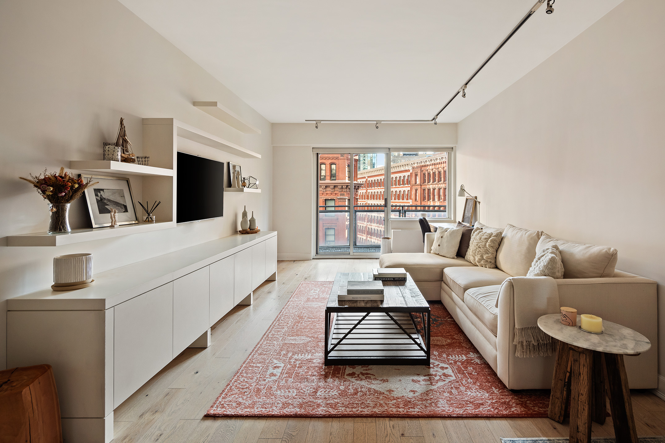 a living room with furniture a rug and a flat screen tv