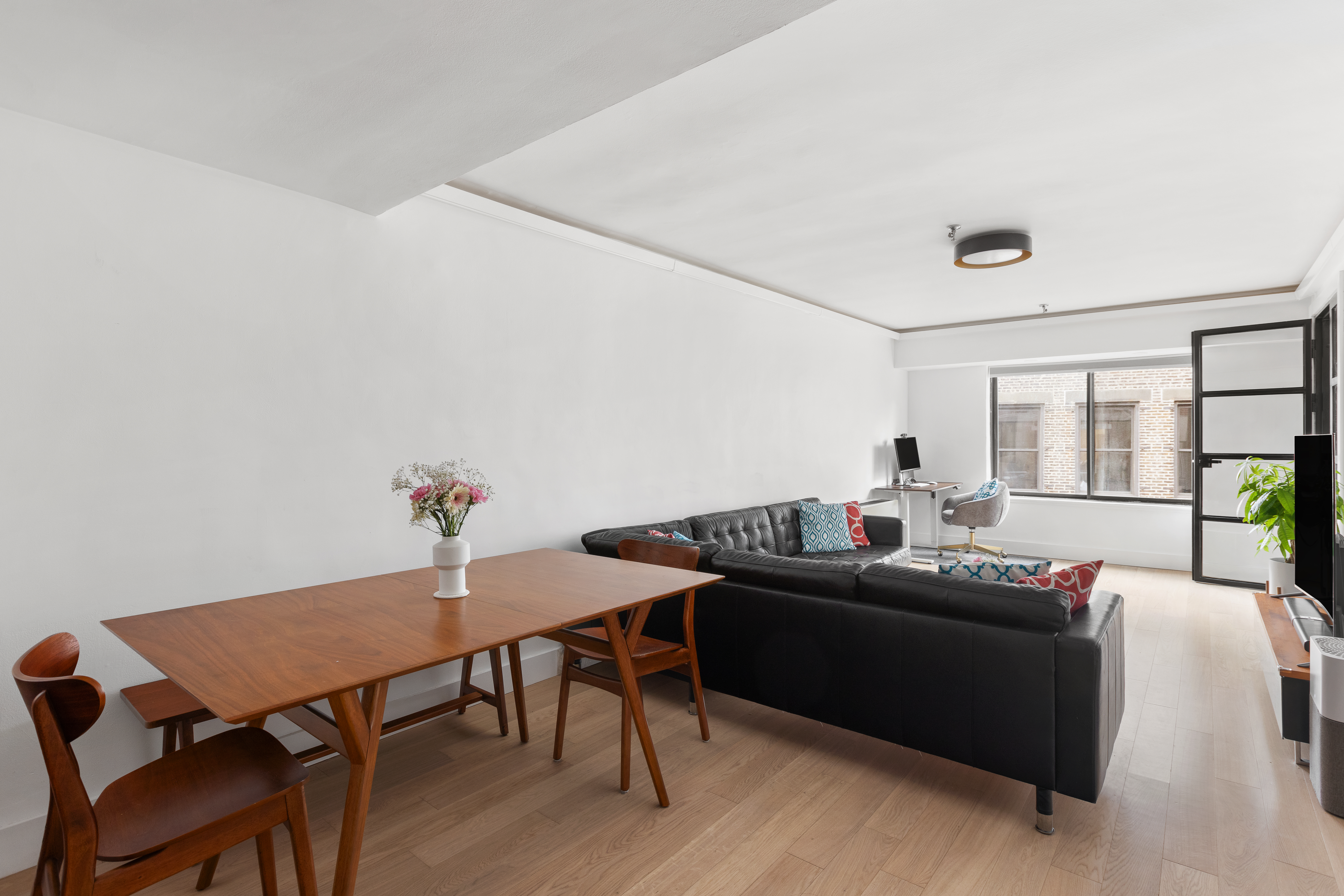 a living room with furniture and wooden floor