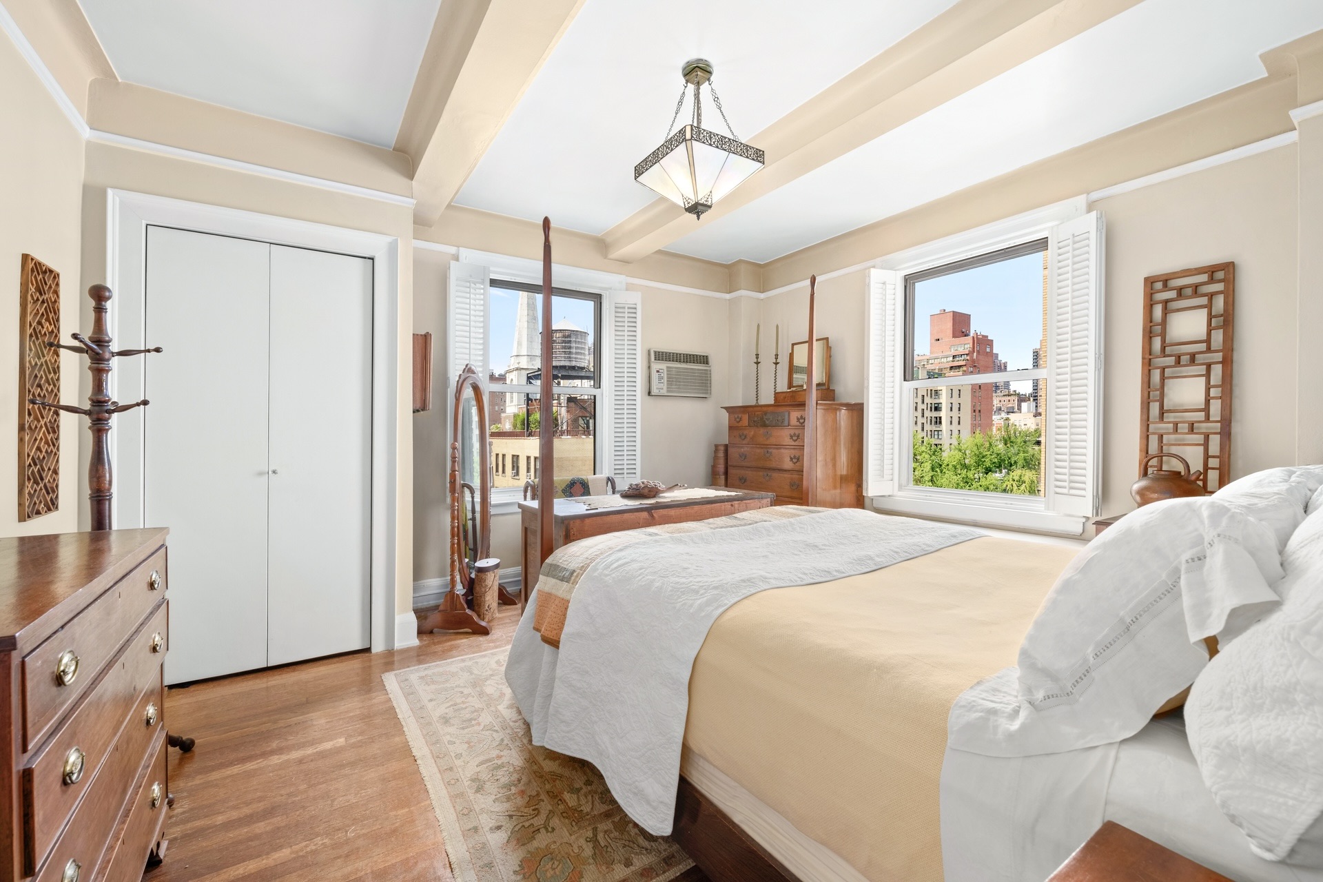 a bedroom with a large bed and a chandelier