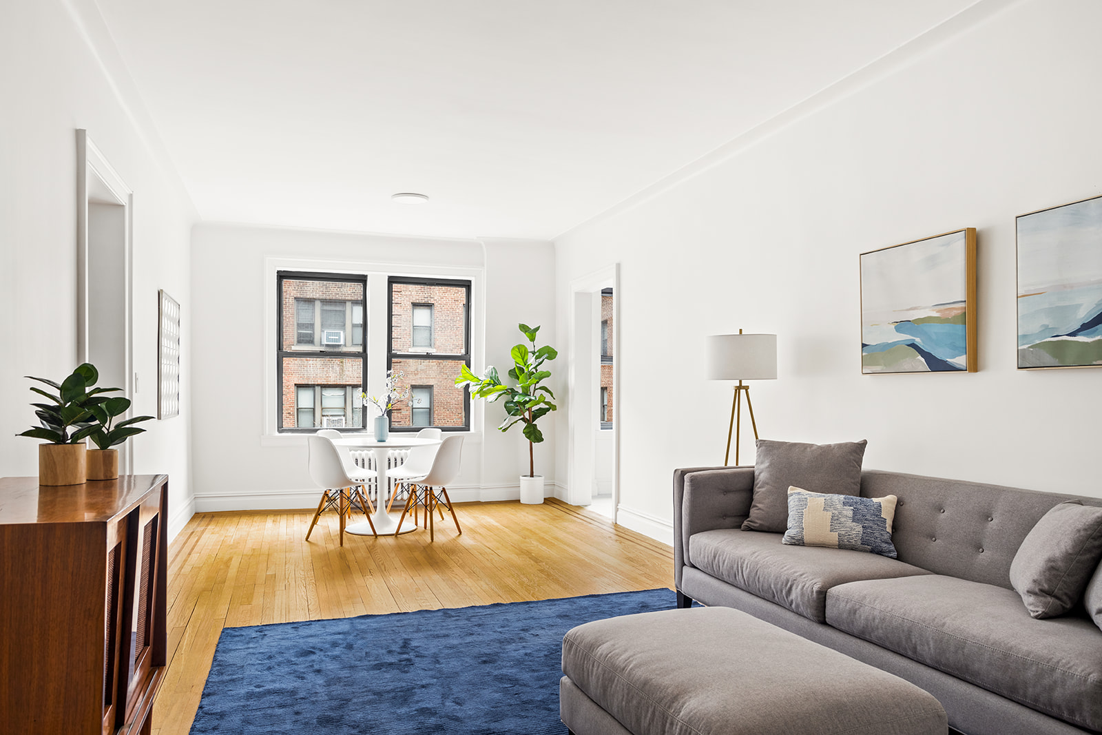 a living room with furniture wooden floor and a table