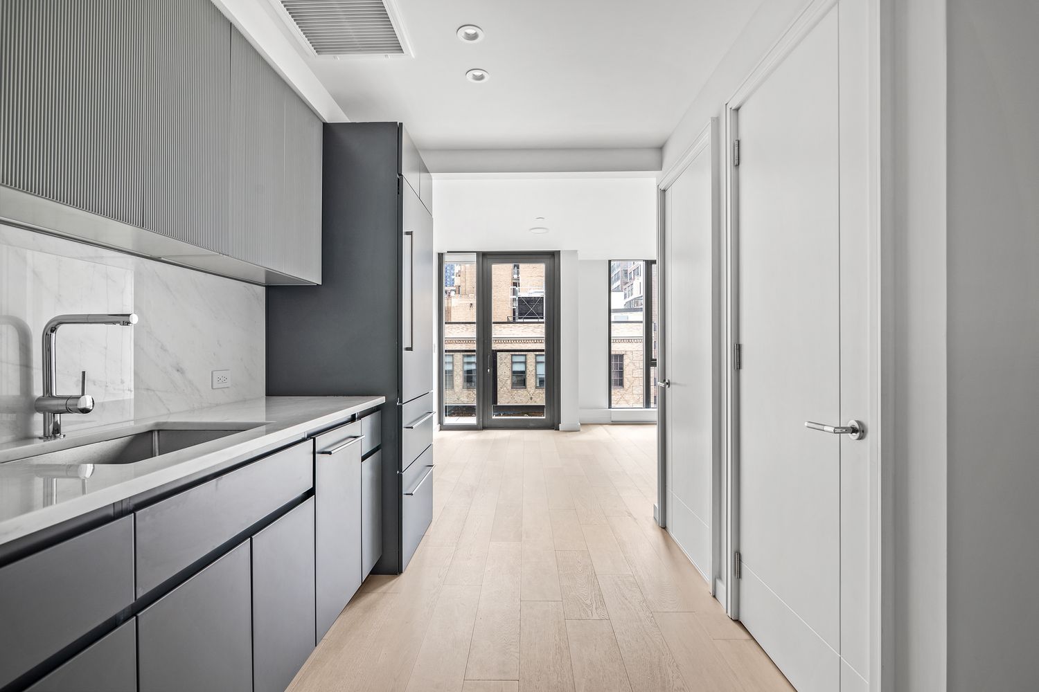 a hallway with sink and mirror