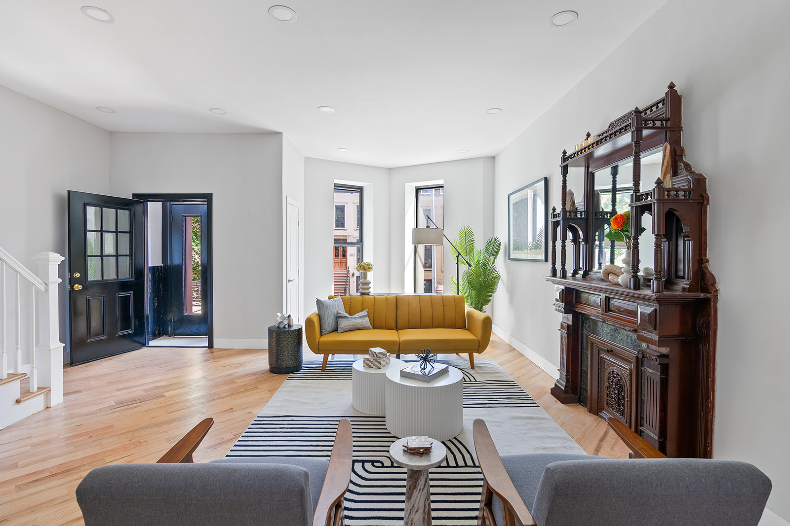 a living room with furniture a bookshelf and a wooden floor