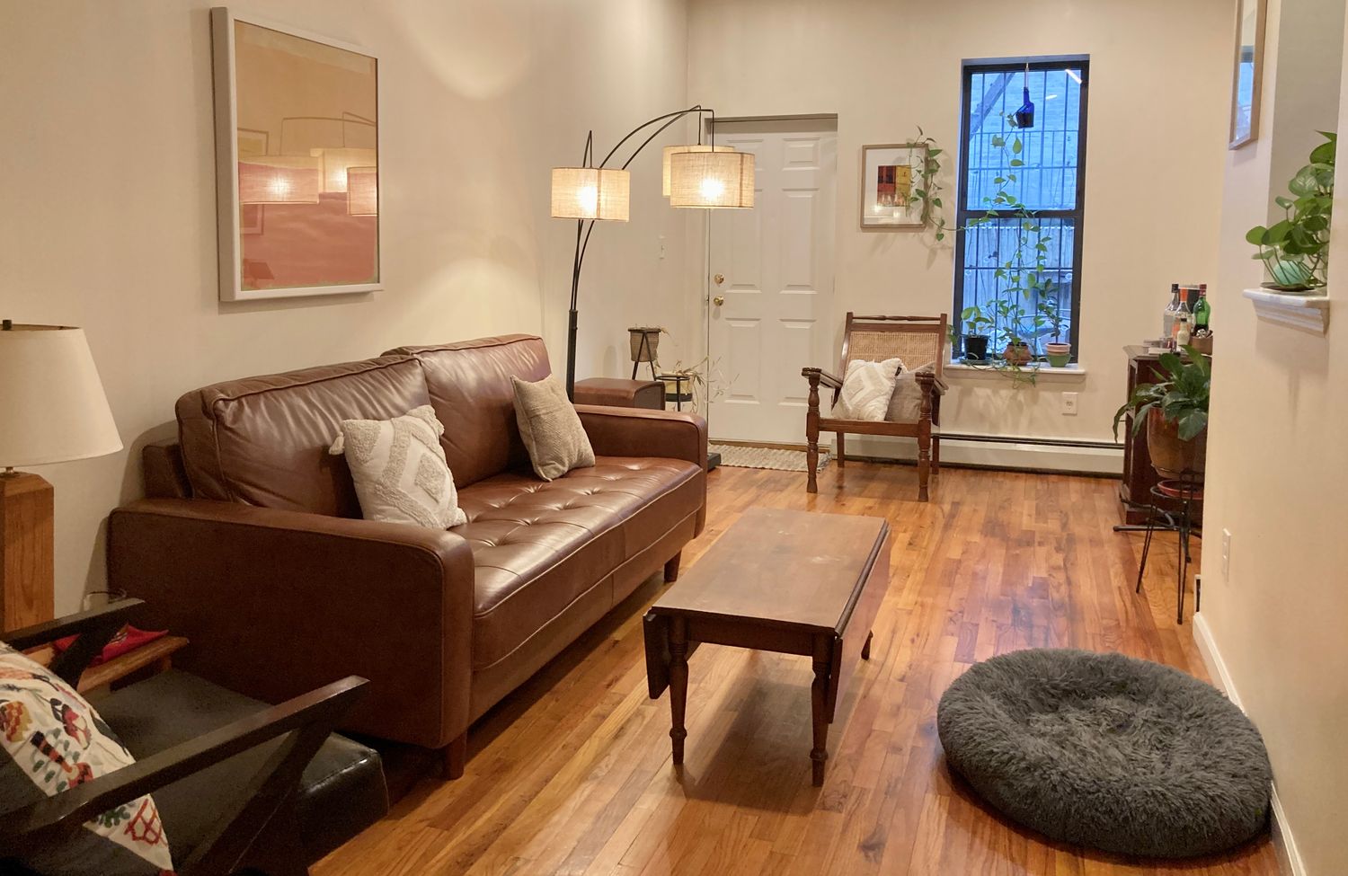 a living room with furniture and wooden floor