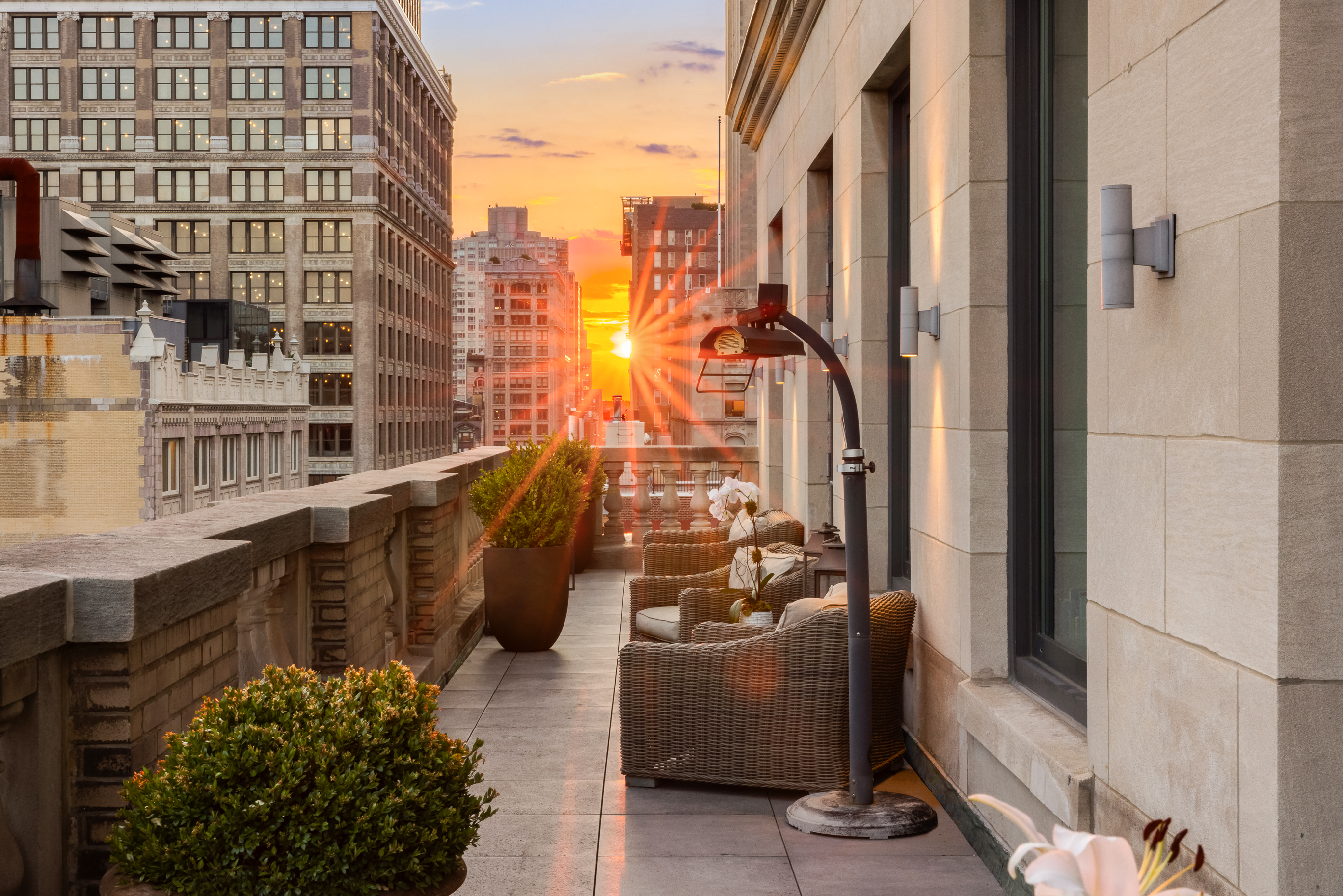 a view of a balcony with chairs and potted plants