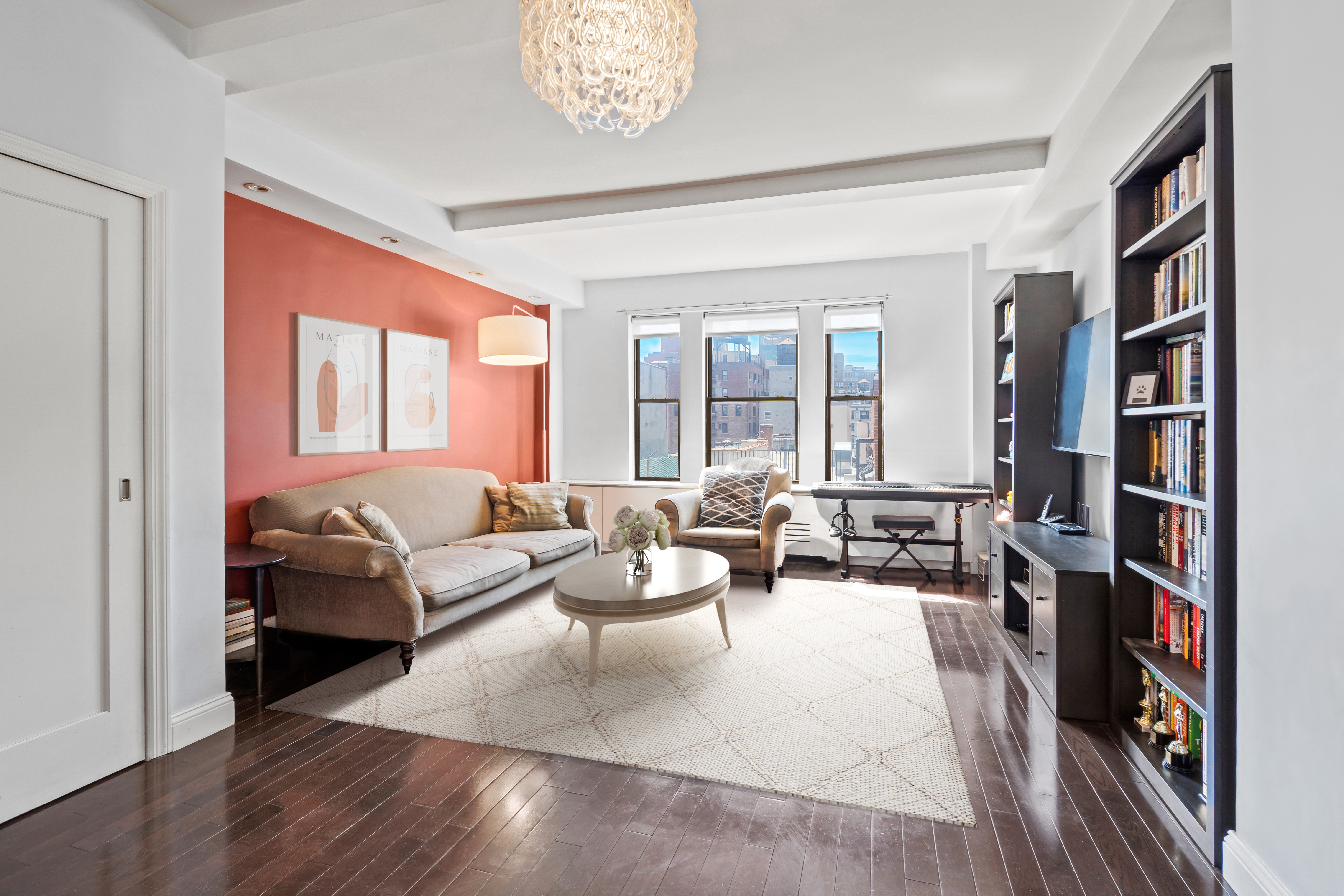 a living room with furniture and a book shelf