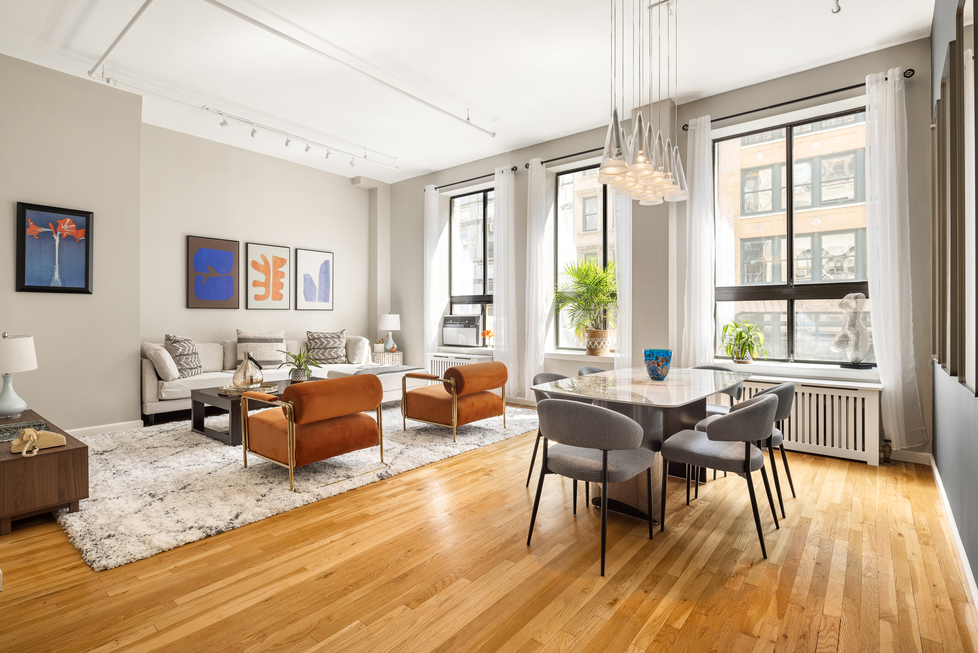 a living room with furniture and wooden floor