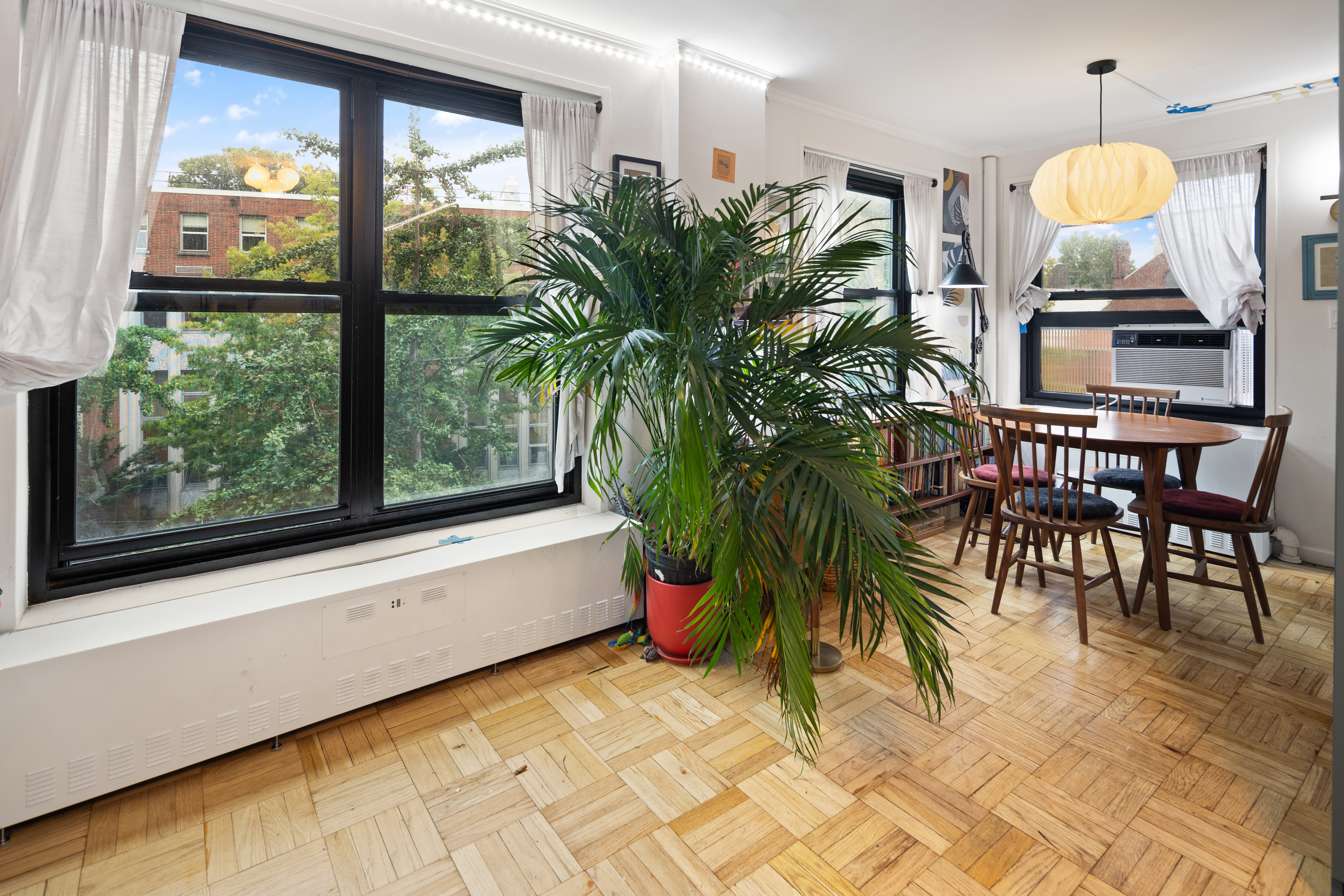 a very nice looking room with a large window and potted plants