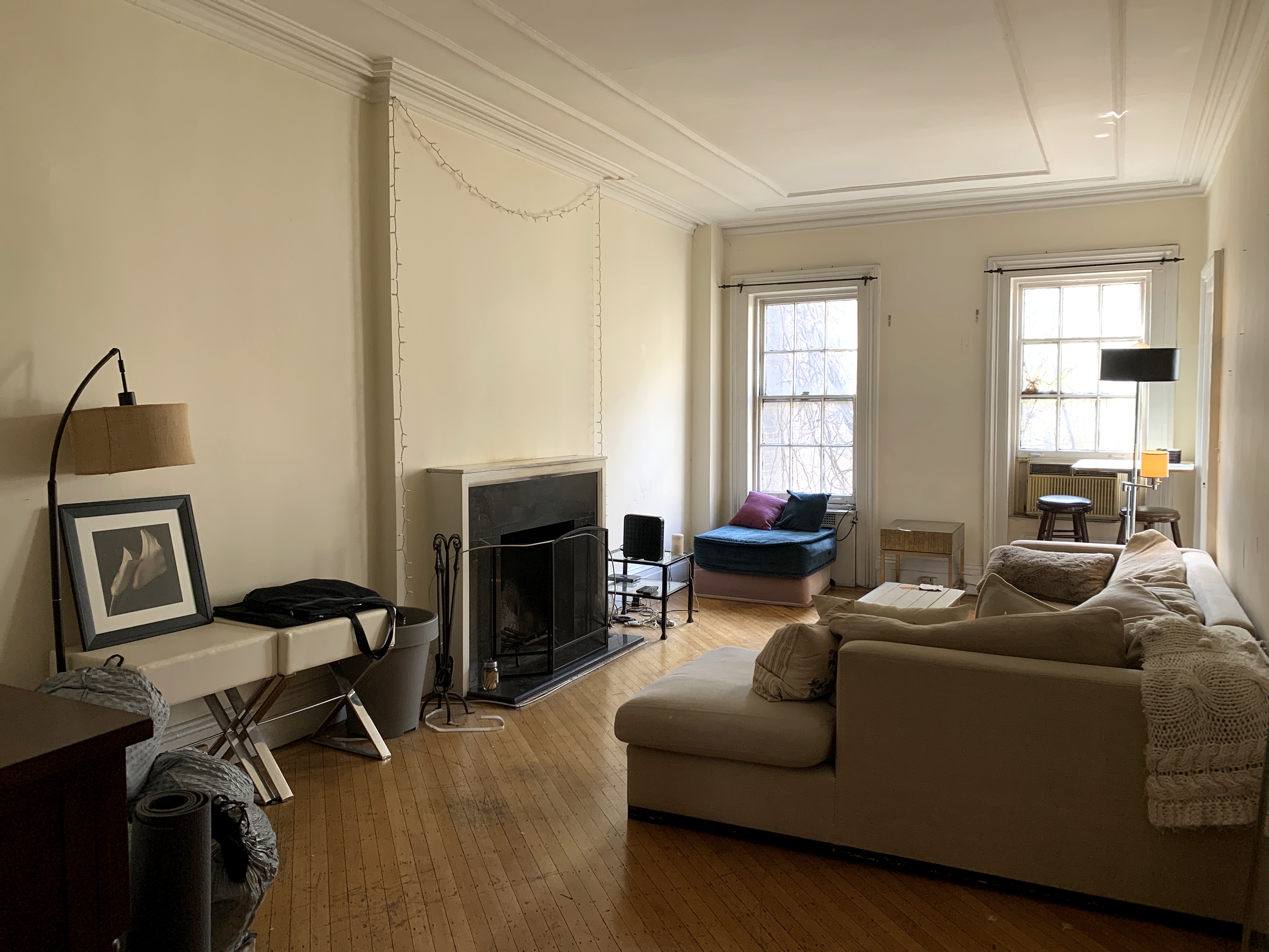 a living room with furniture a fireplace and a window