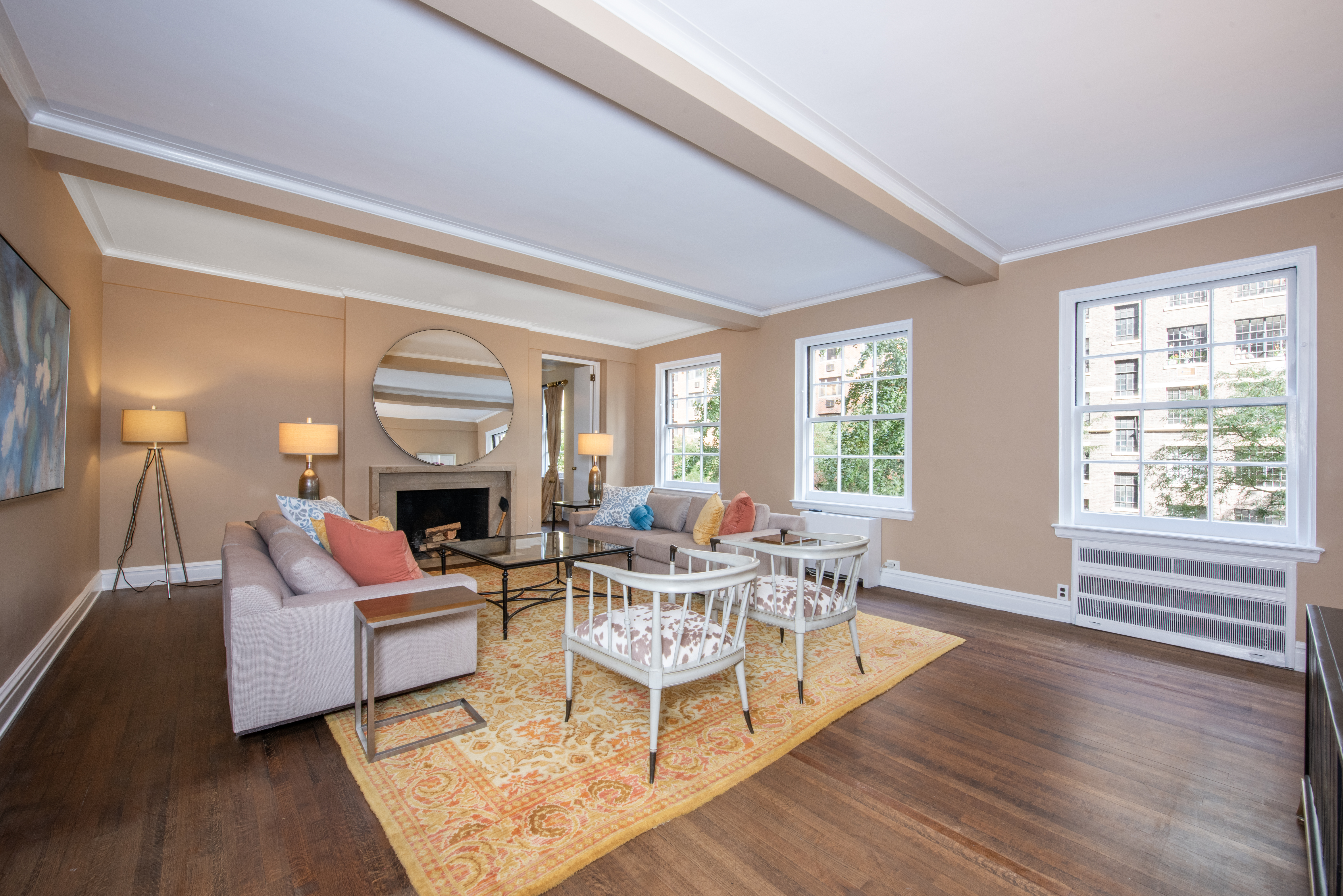 a living room with fireplace furniture and a large window