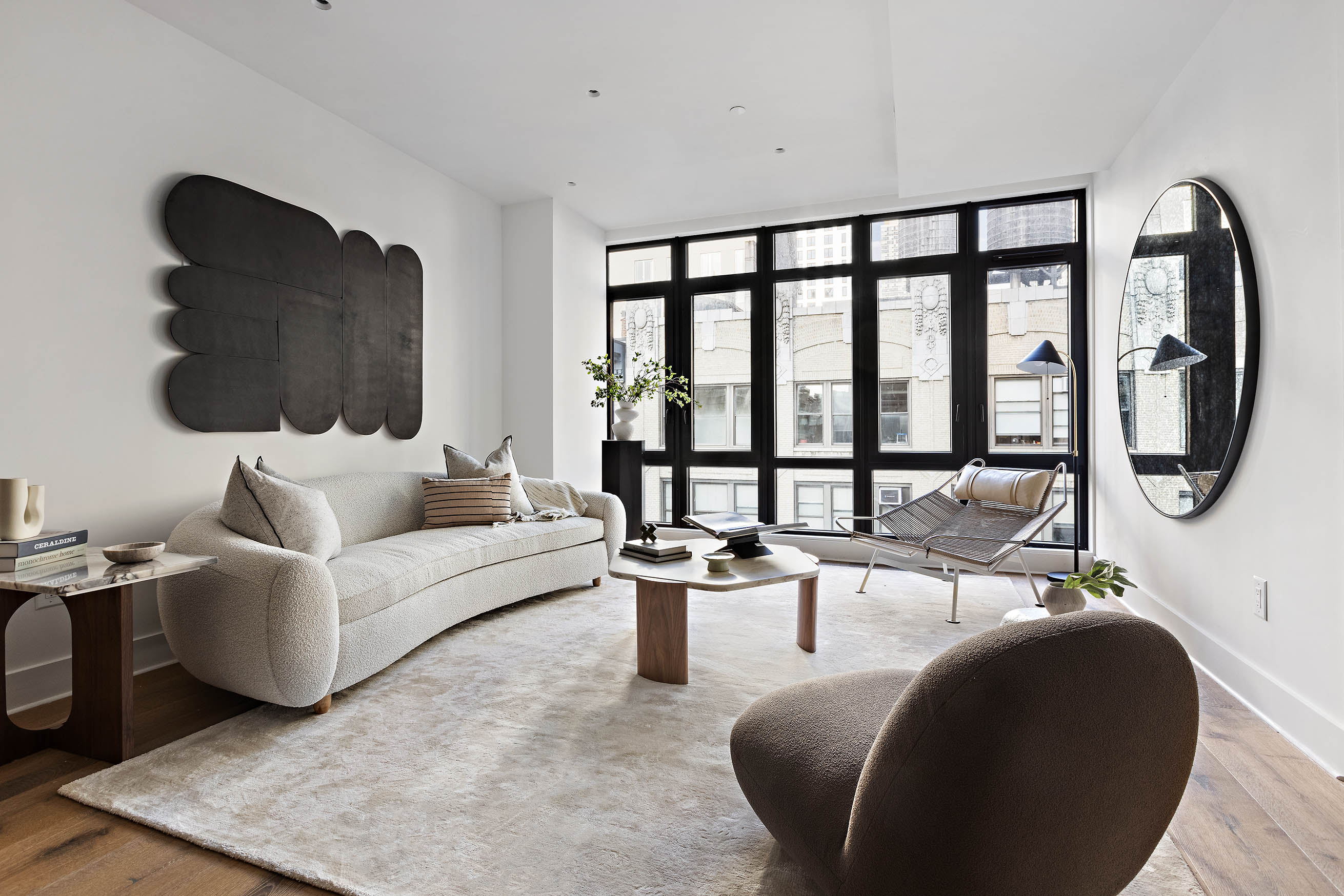 a living room with furniture and a floor to ceiling window