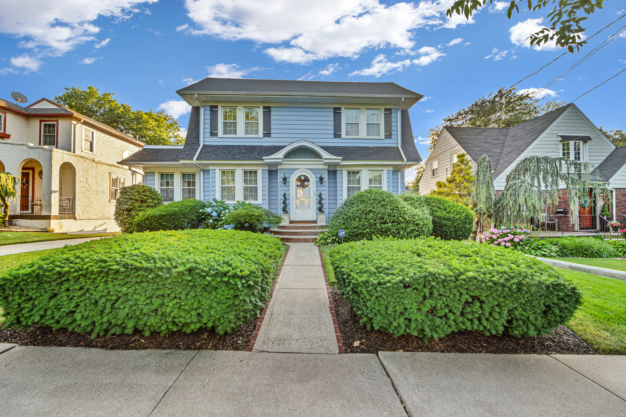 front view of a house with a garden