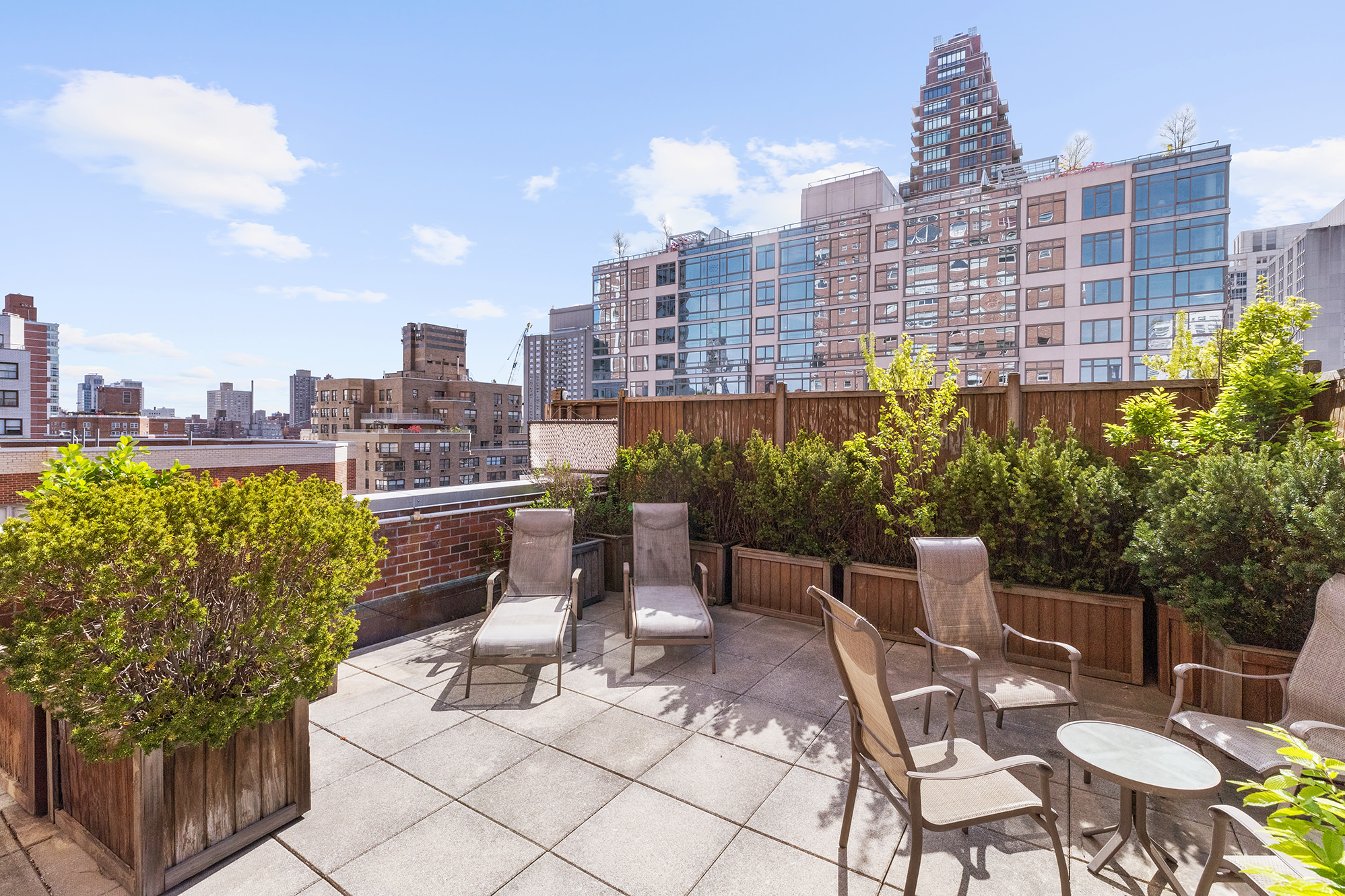 a view of a terrace with chairs and a table