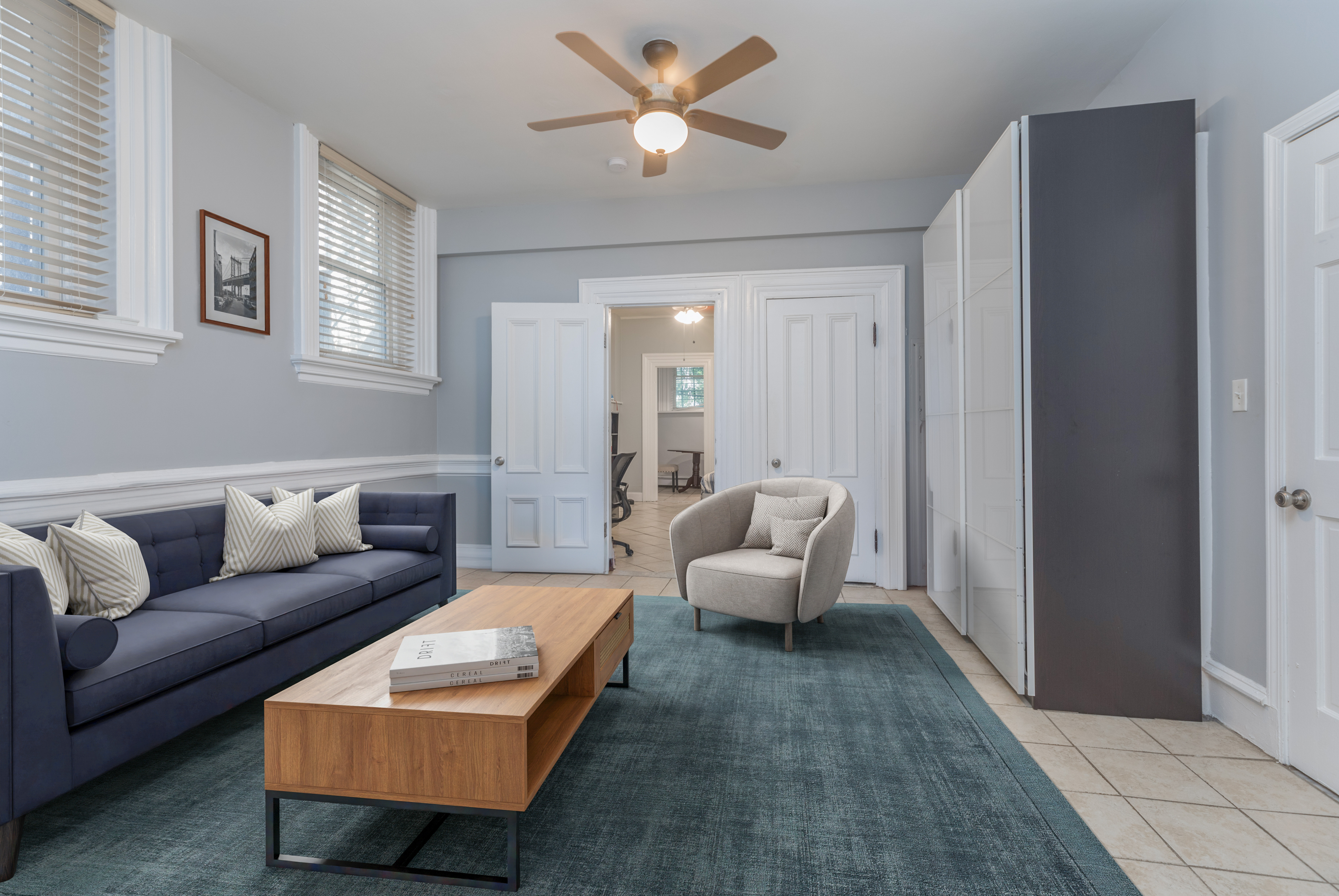 a living room with furniture and a lamp