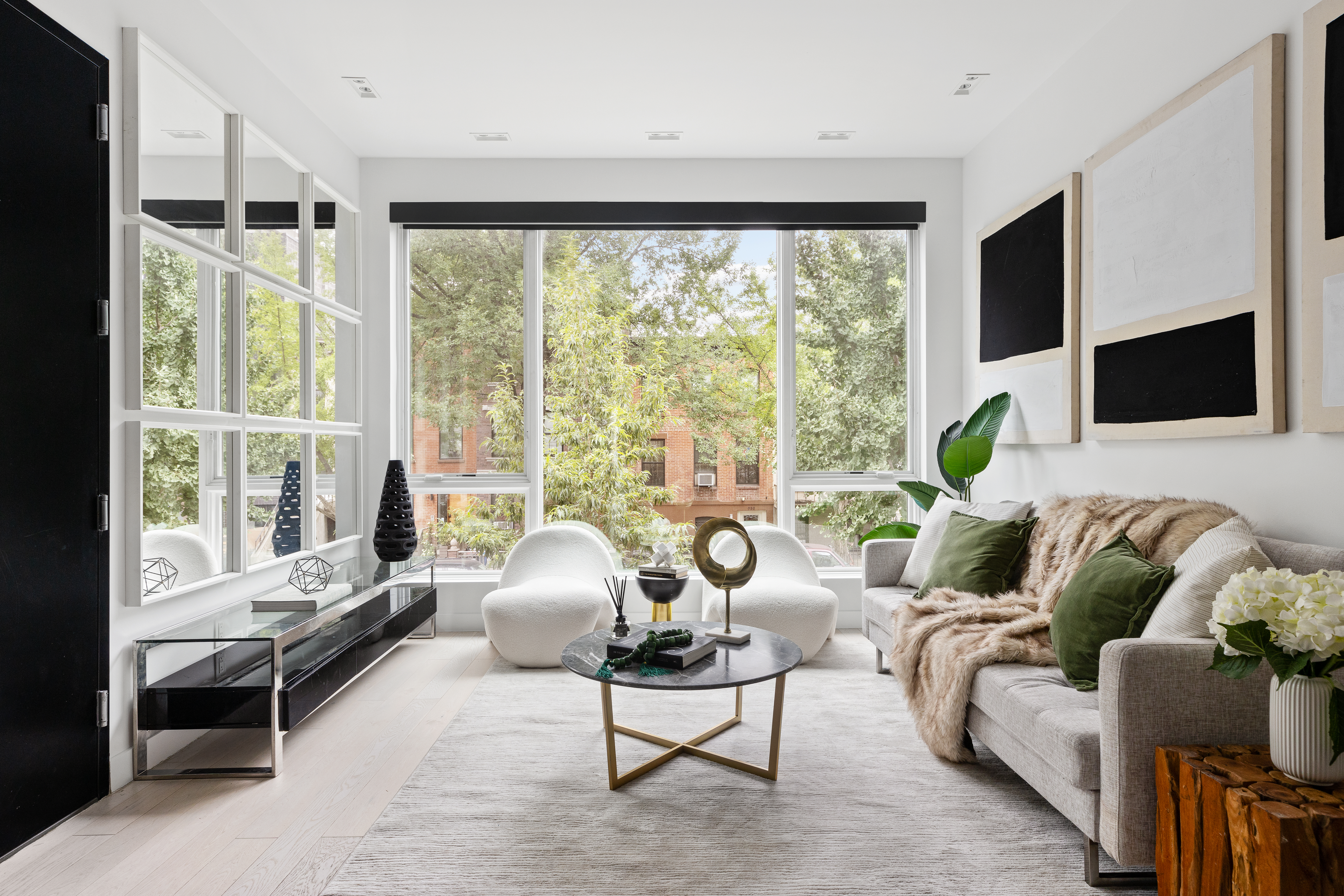 a living room with furniture large window and flat screen tv