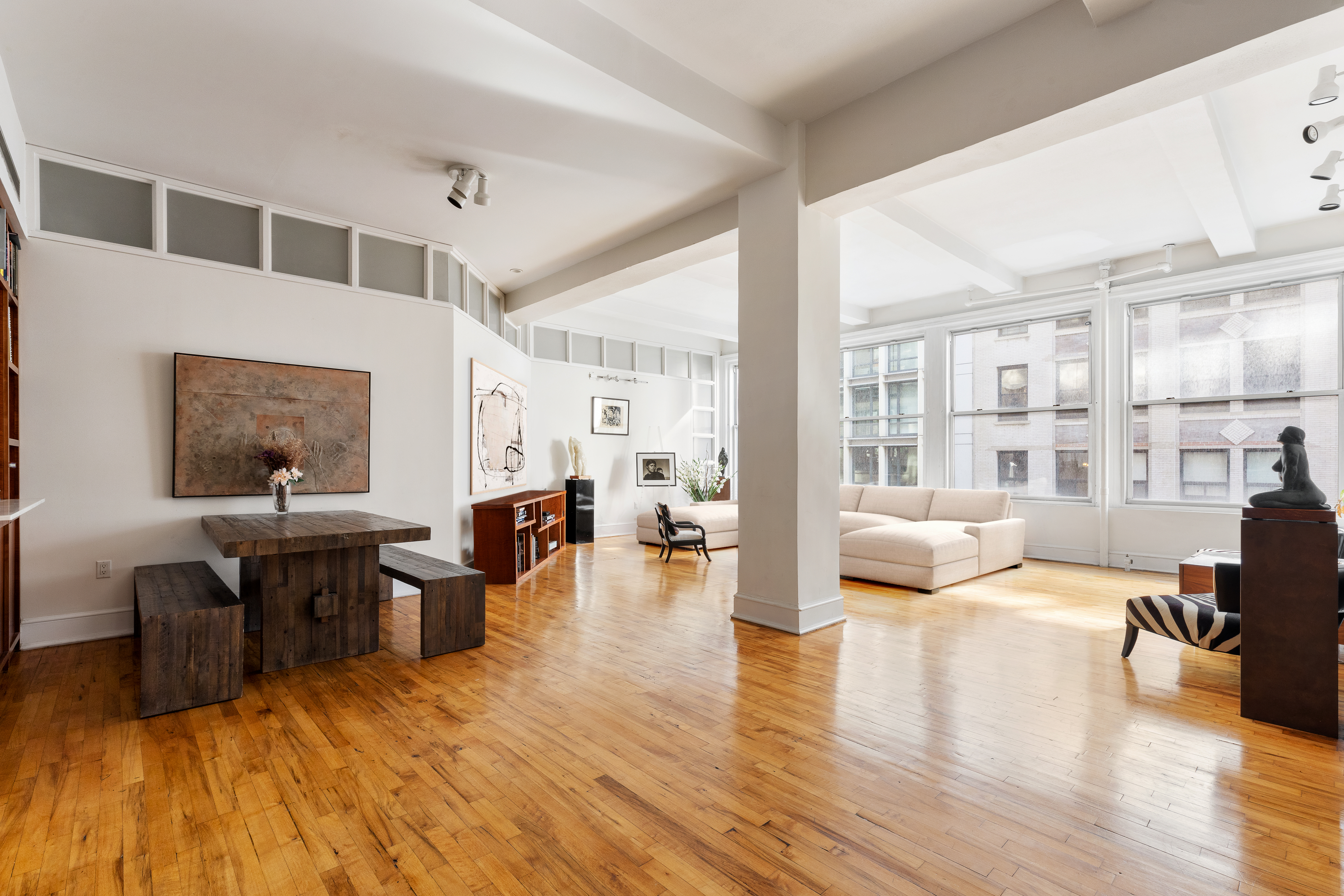 a living room with furniture and a wooden floor