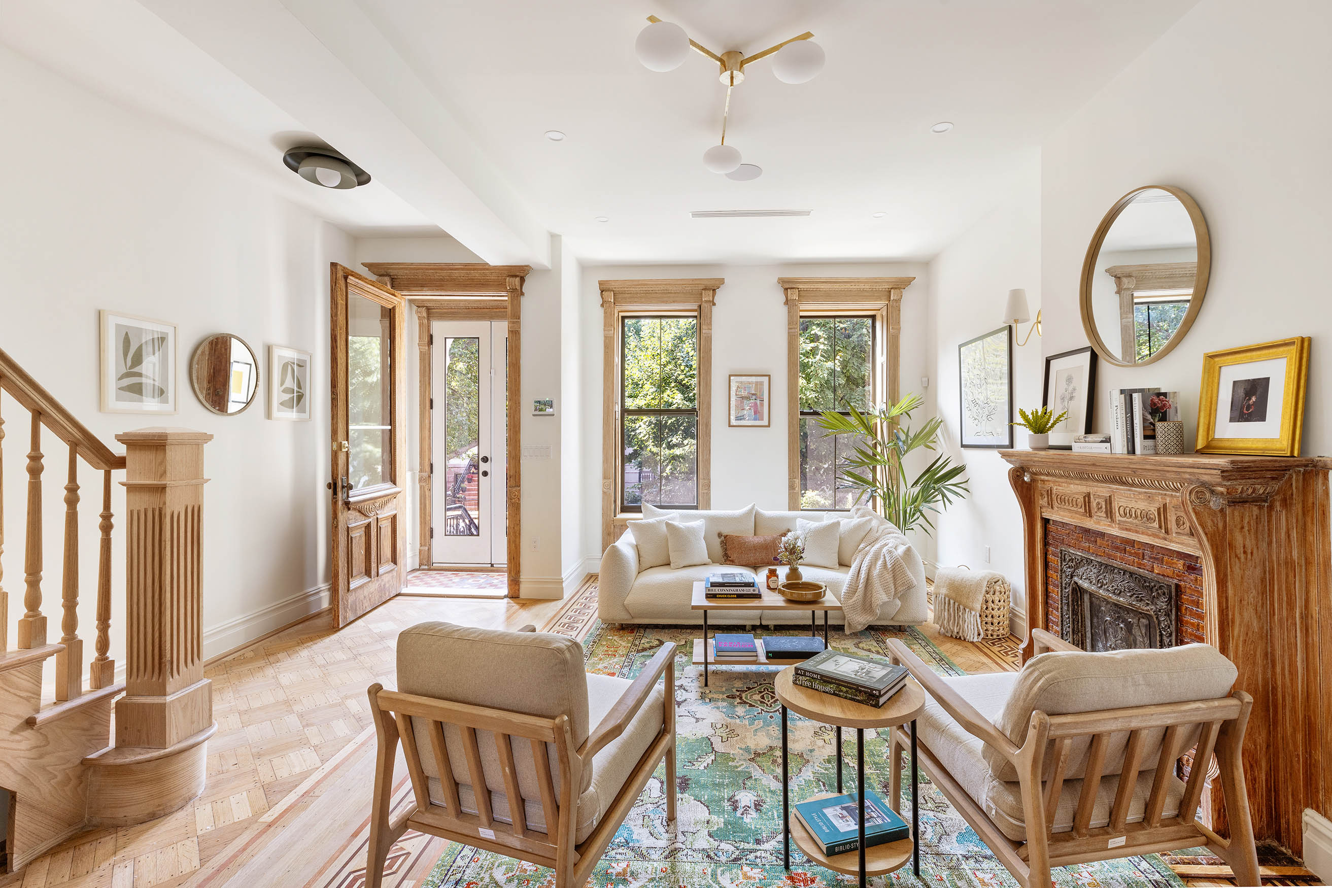 a living room with furniture a fireplace and a large window