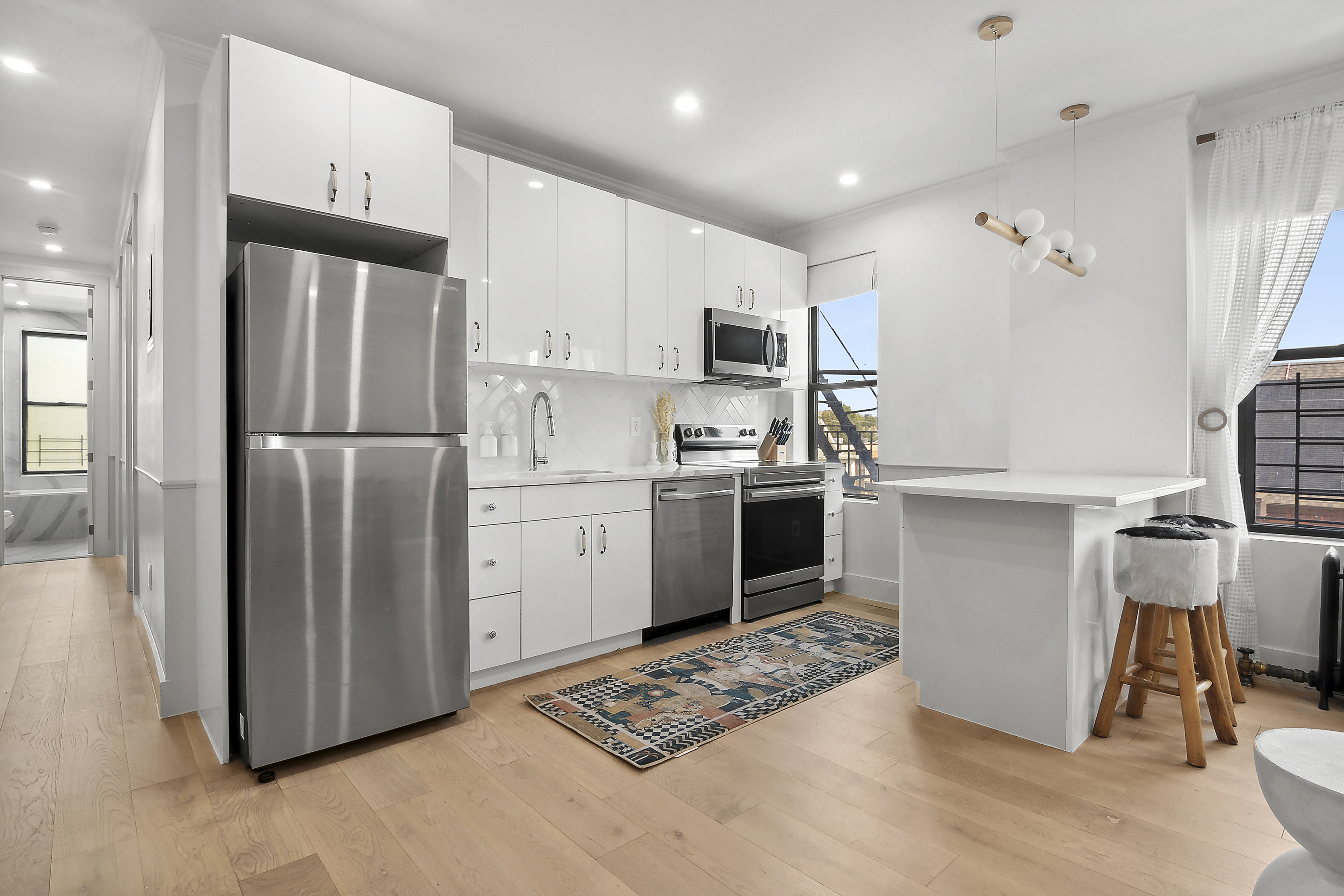 a kitchen with stainless steel appliances granite countertop a refrigerator sink and stove