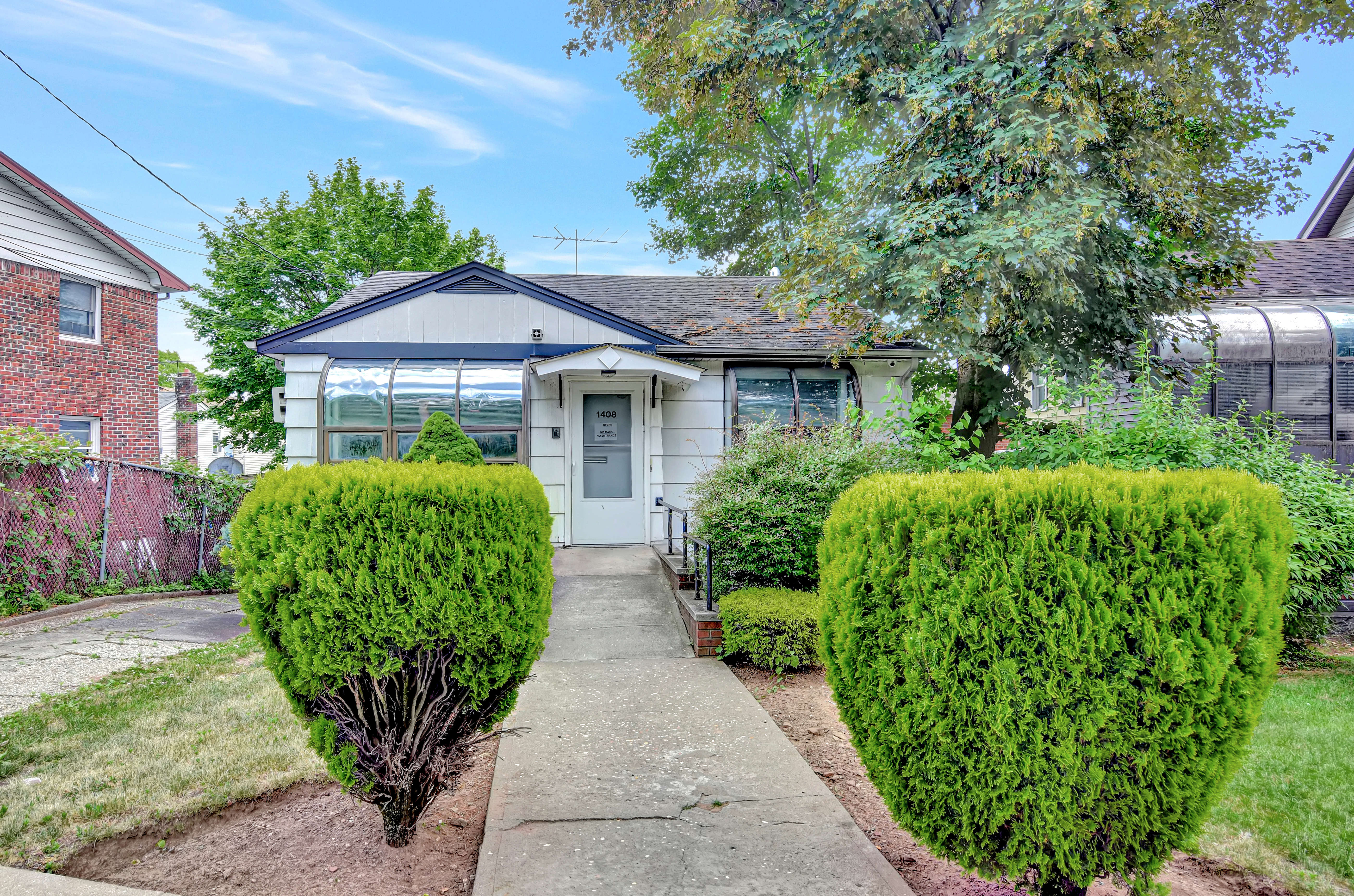 a front view of a house with garden