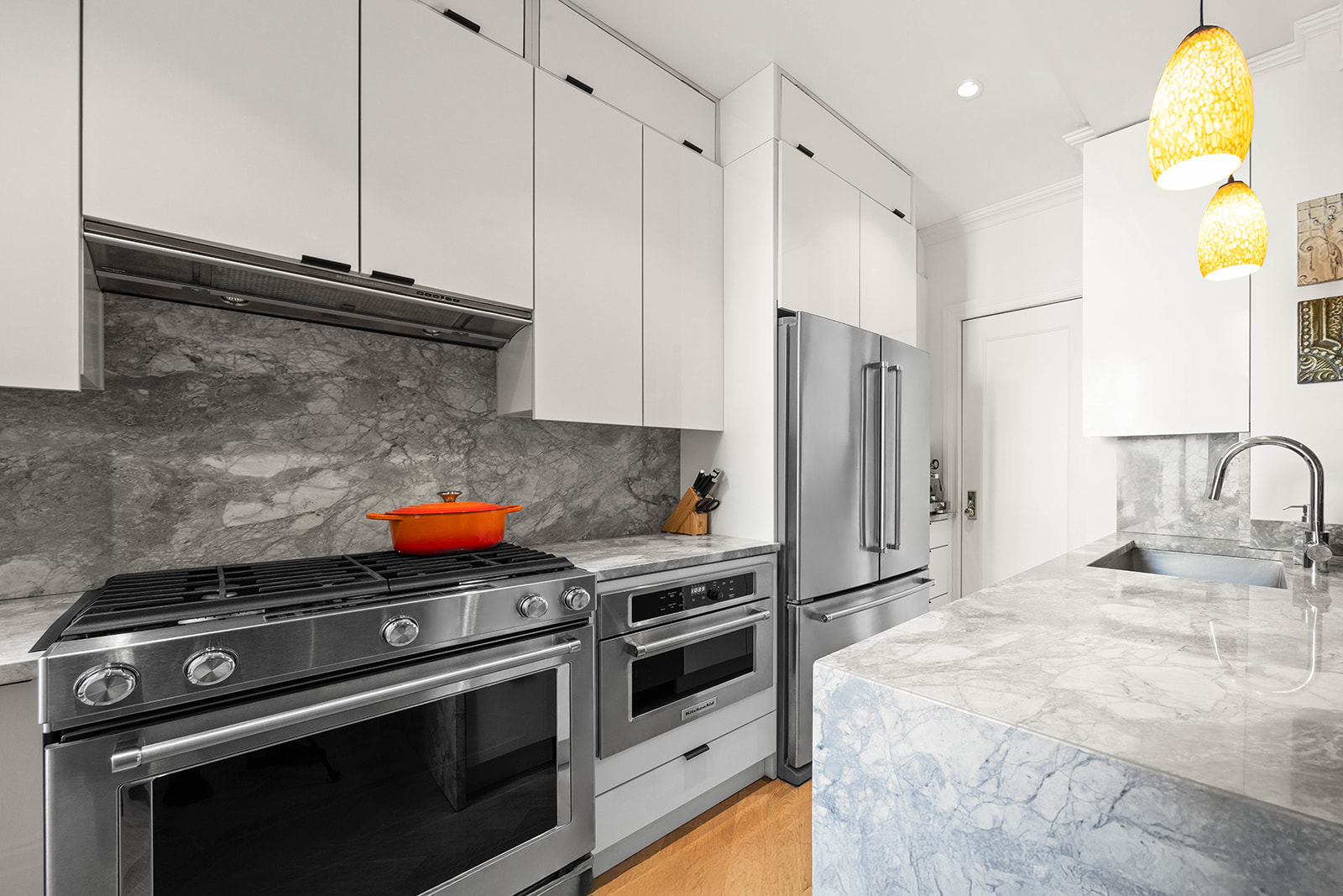 a kitchen with stainless steel appliances a stove a sink and a refrigerator