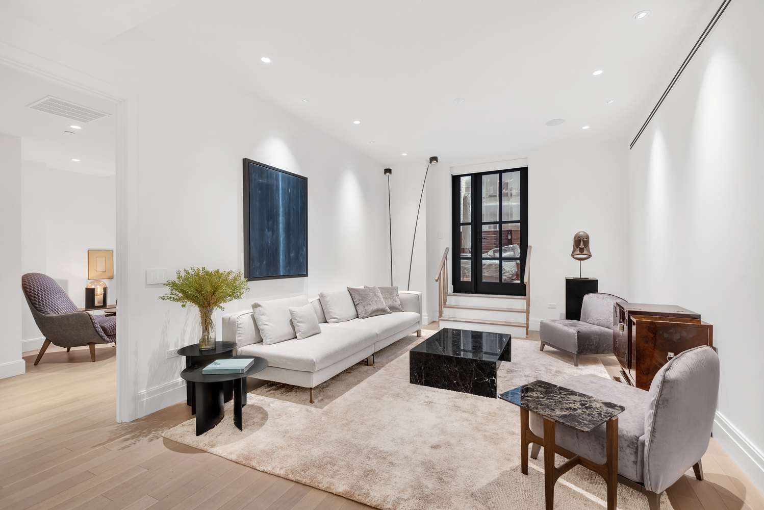 a living room with furniture and wooden floor