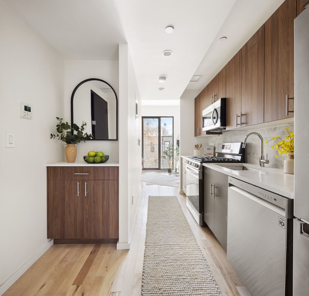 a kitchen with sink a refrigerator and cabinets