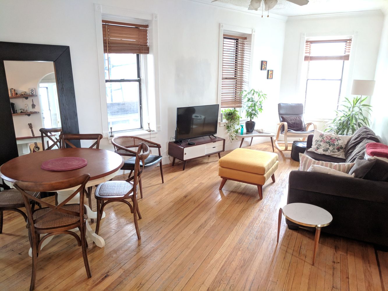 a living room with furniture and a wooden floor