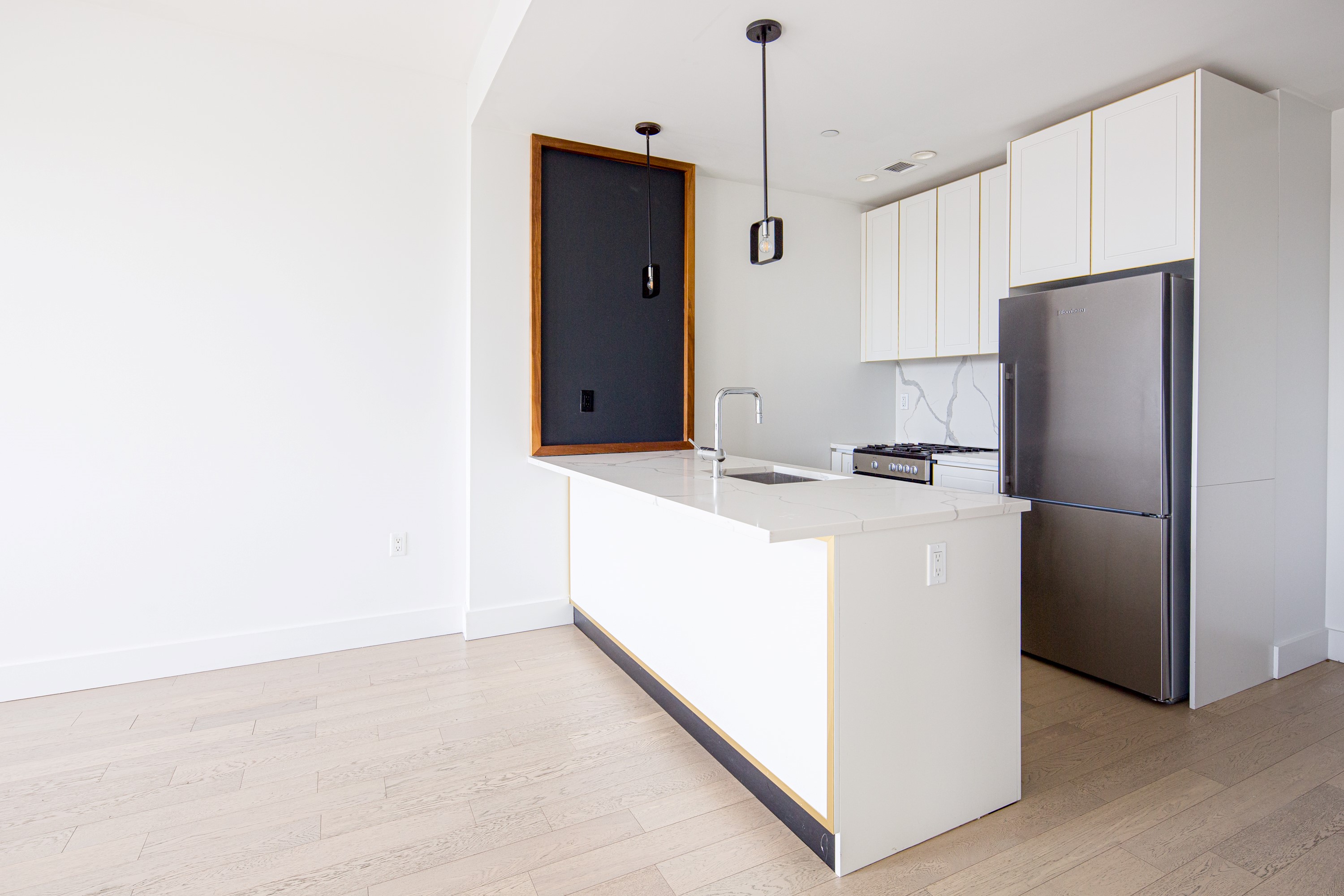 a kitchen that has a refrigerator a stove and a microwave