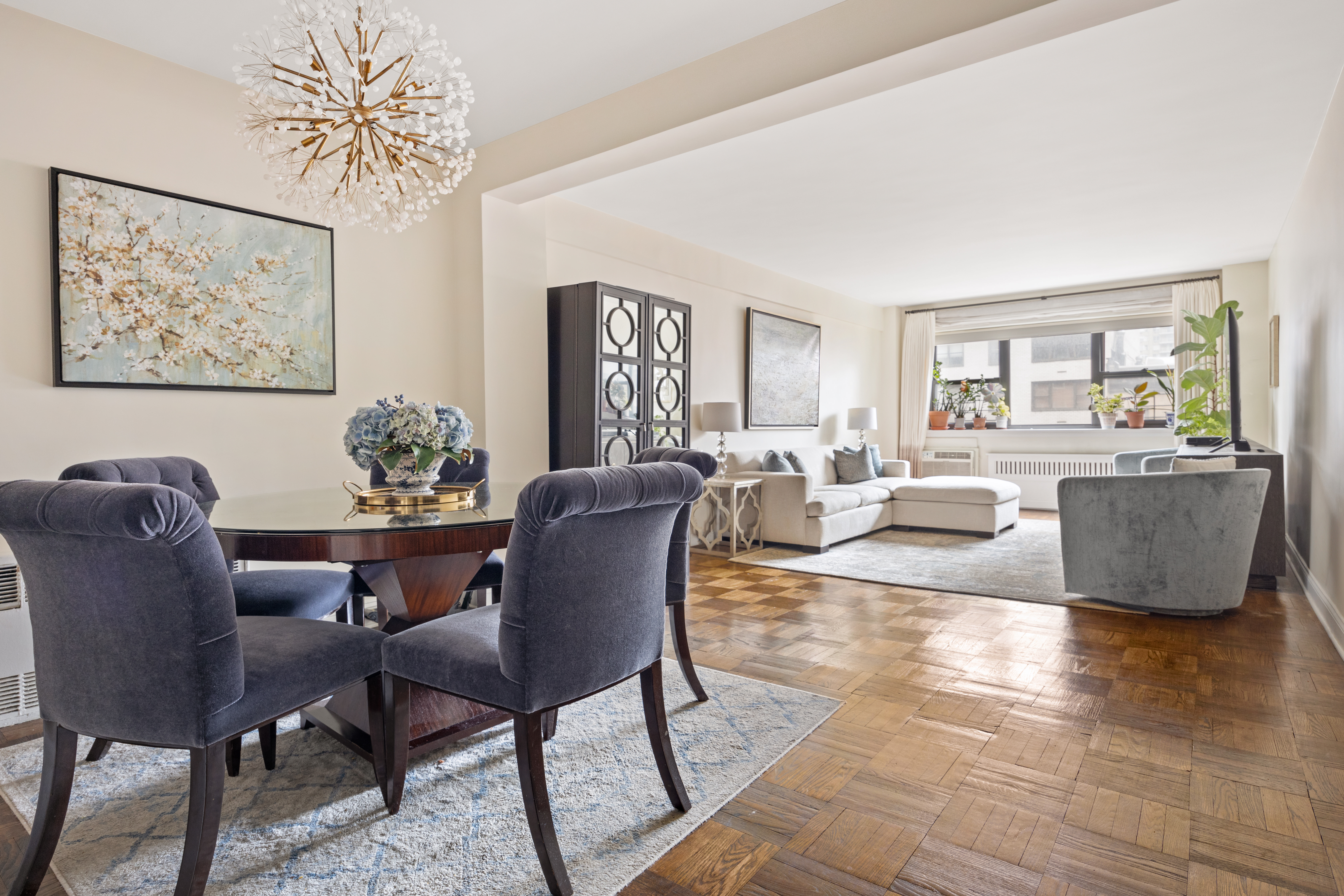 a living room with furniture wooden floor and a table