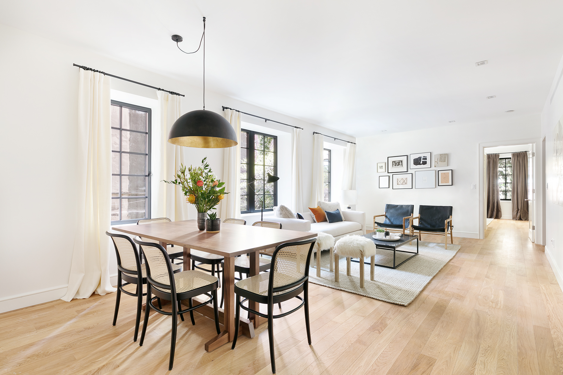 a view of a dining room with furniture window and wooden floor