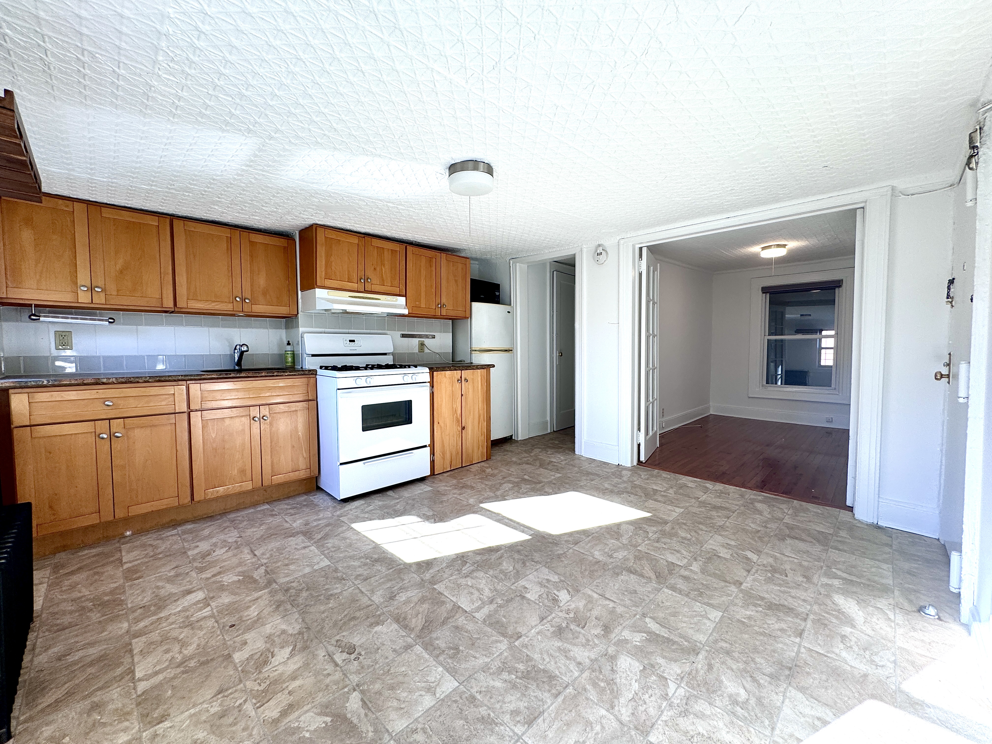 a kitchen with a stove a sink and a refrigerator