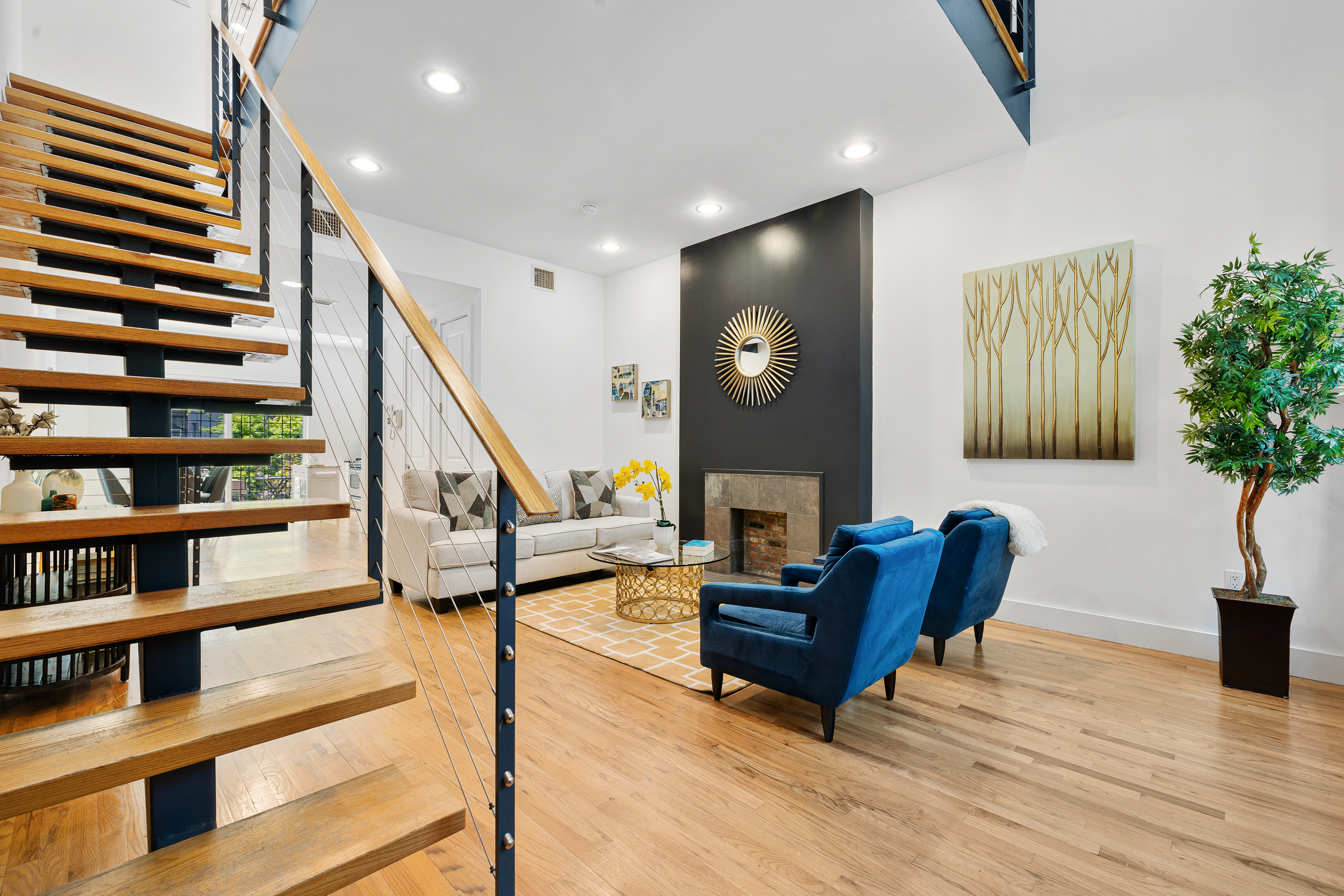 a living room with furniture and a book shelf