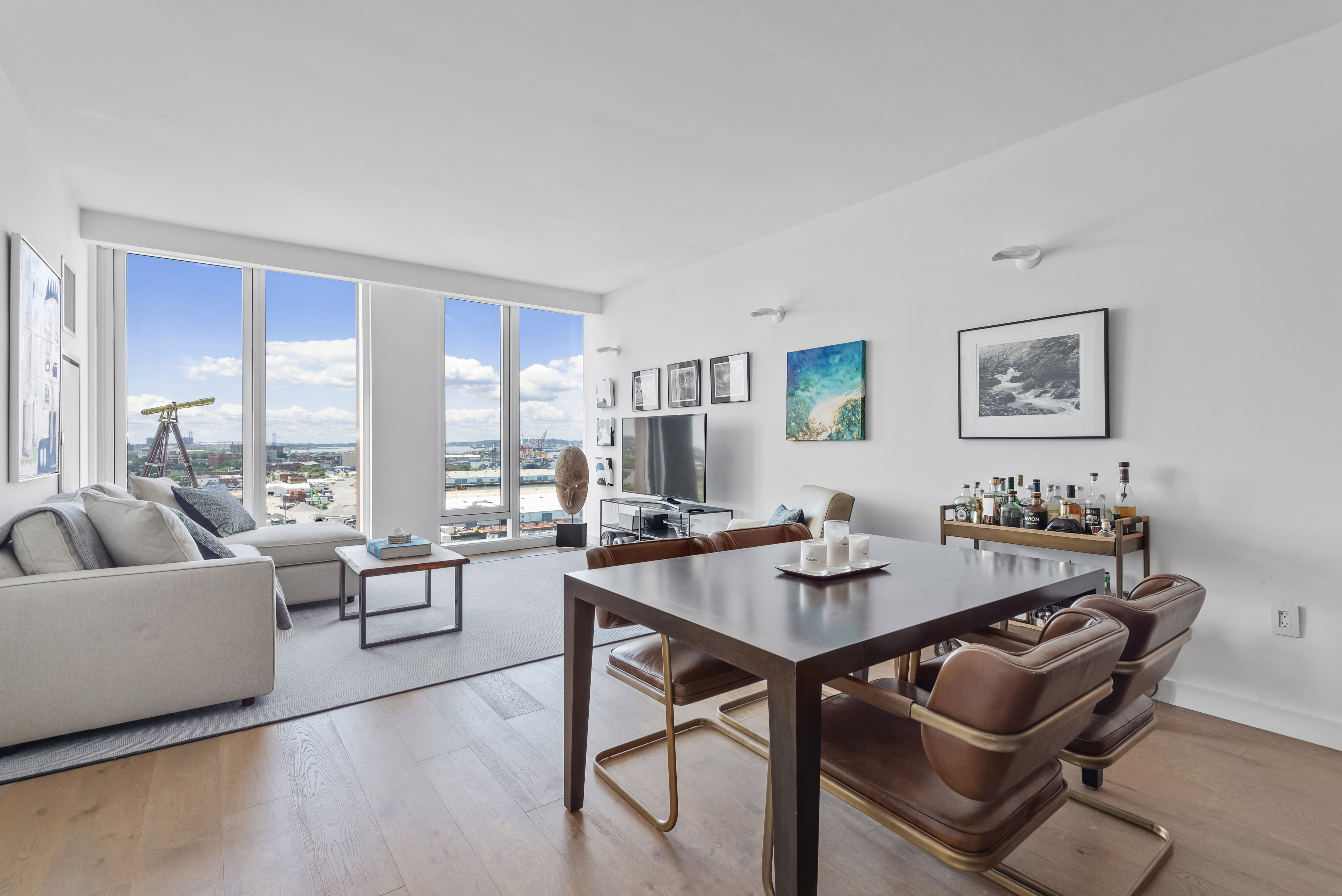 a dining room with furniture and a floor to ceiling window