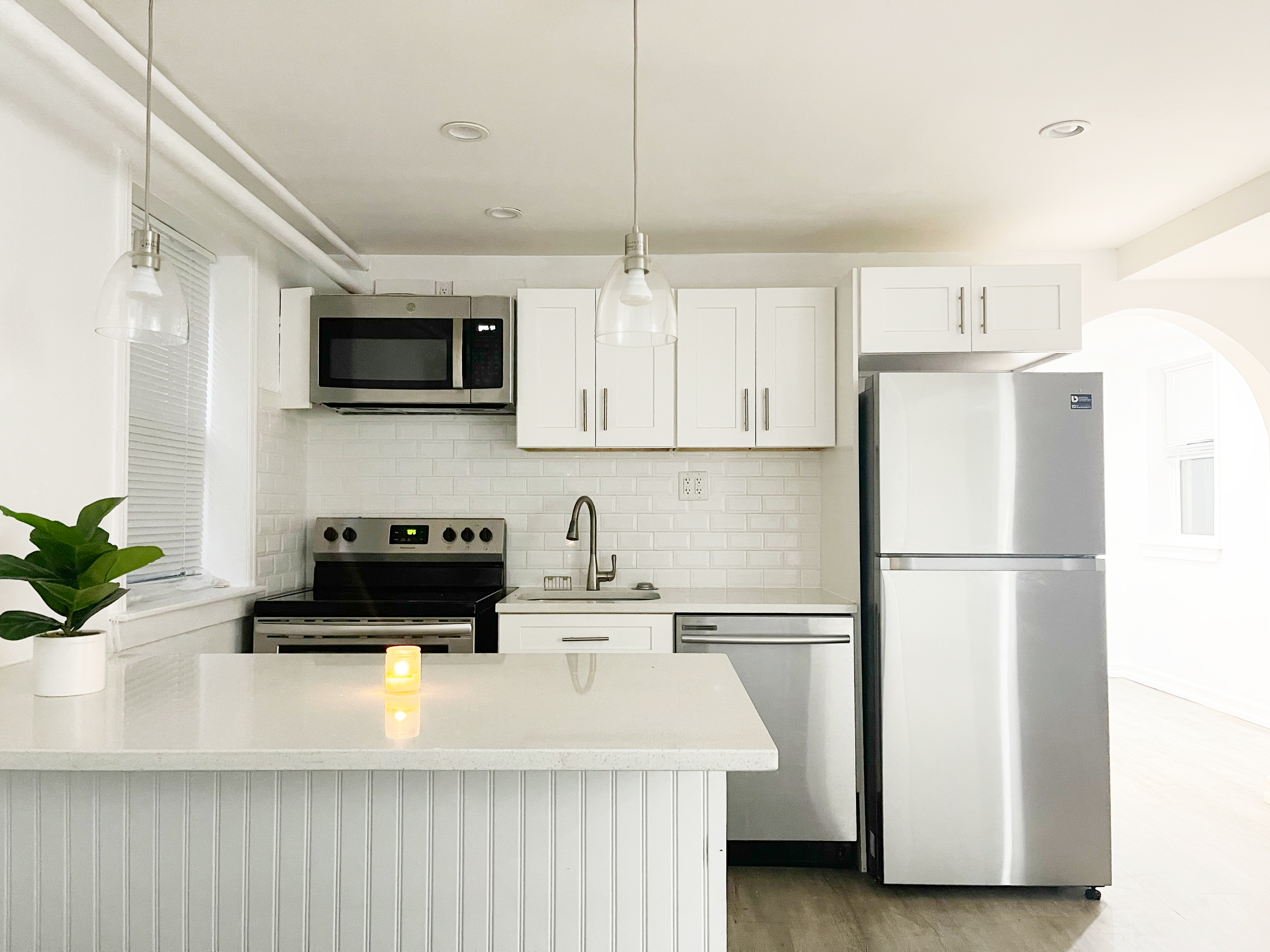 a kitchen with a refrigerator a microwave and cabinets