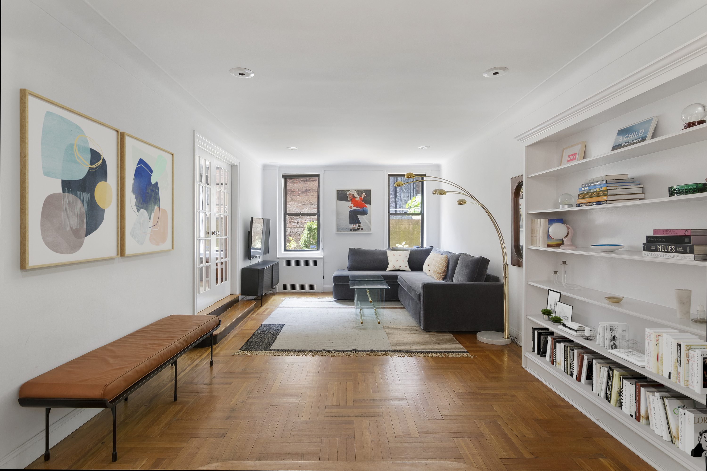 a living room with furniture and baby crib