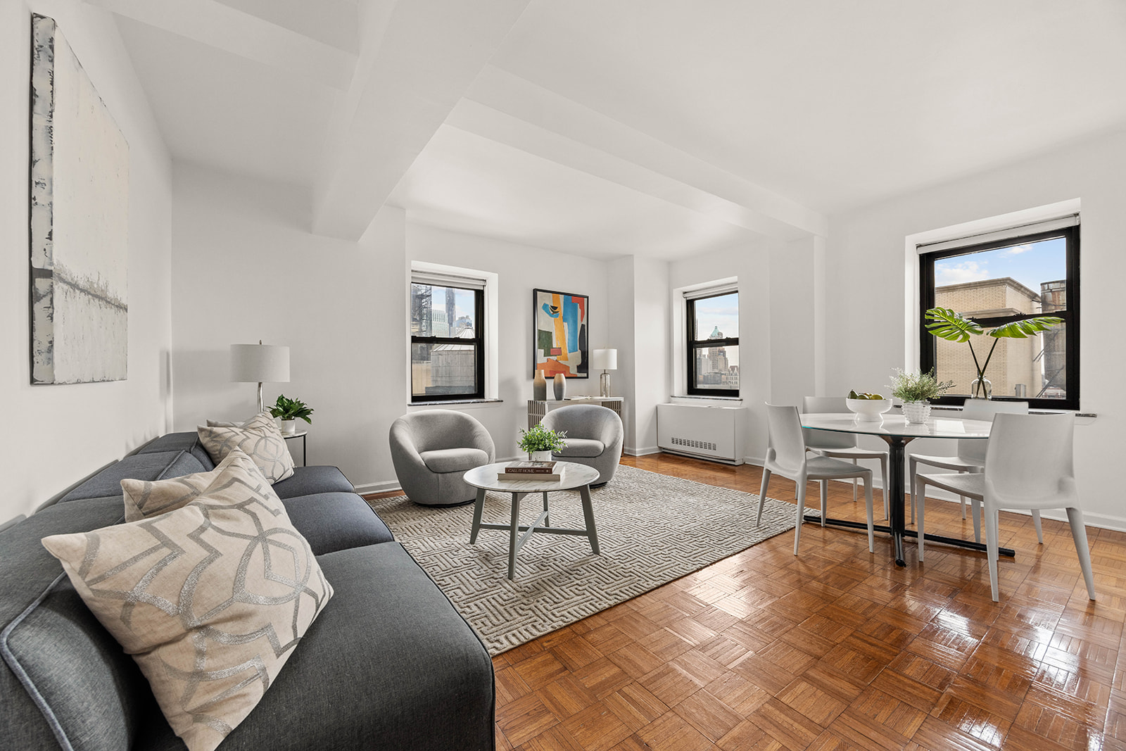 a living room with furniture a wooden floor and a window