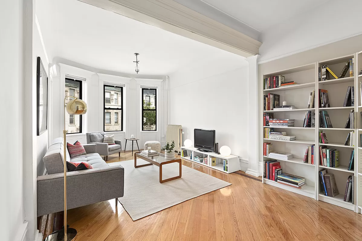 a living room with furniture a rug and a window