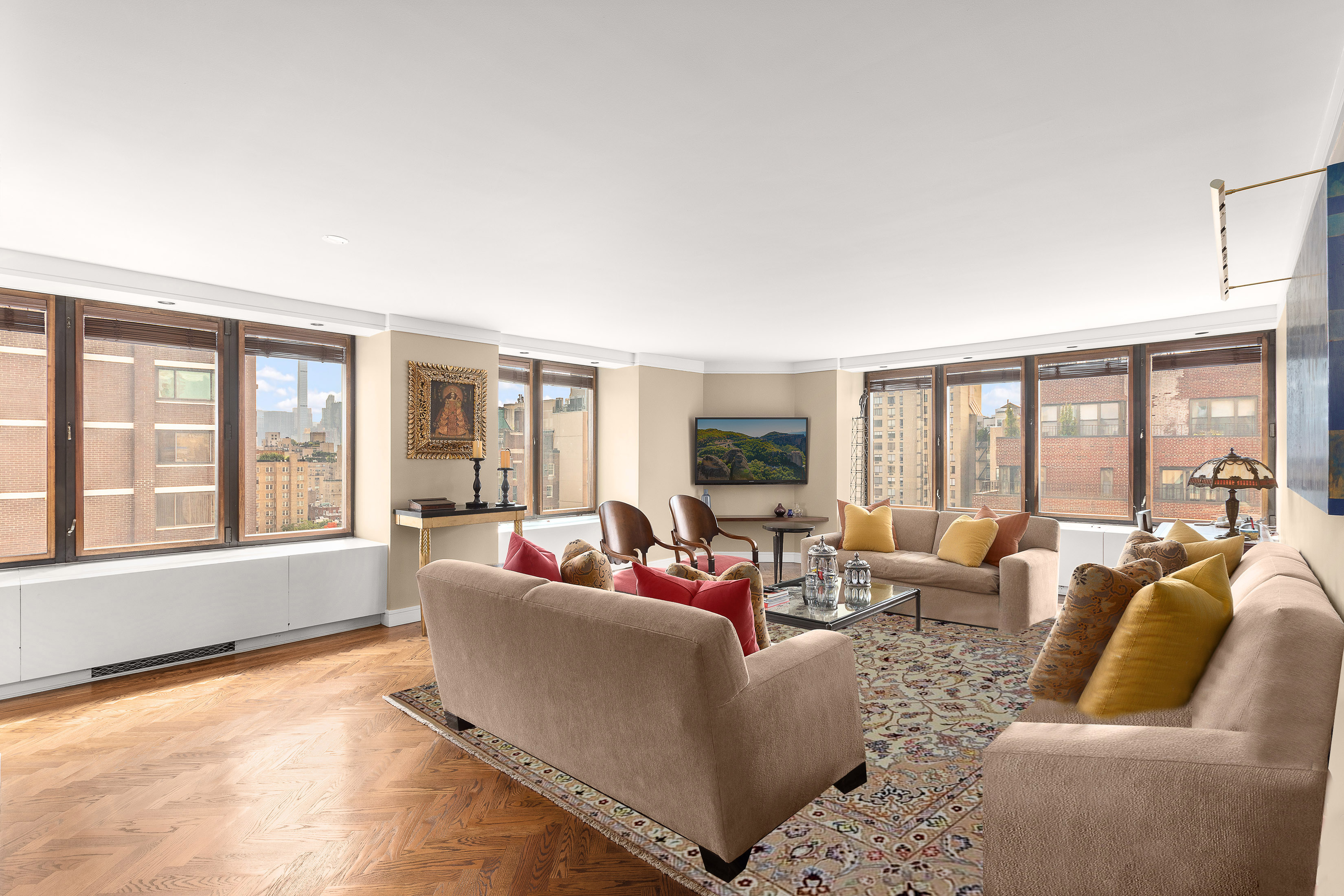 a living room with furniture and floor to ceiling windows