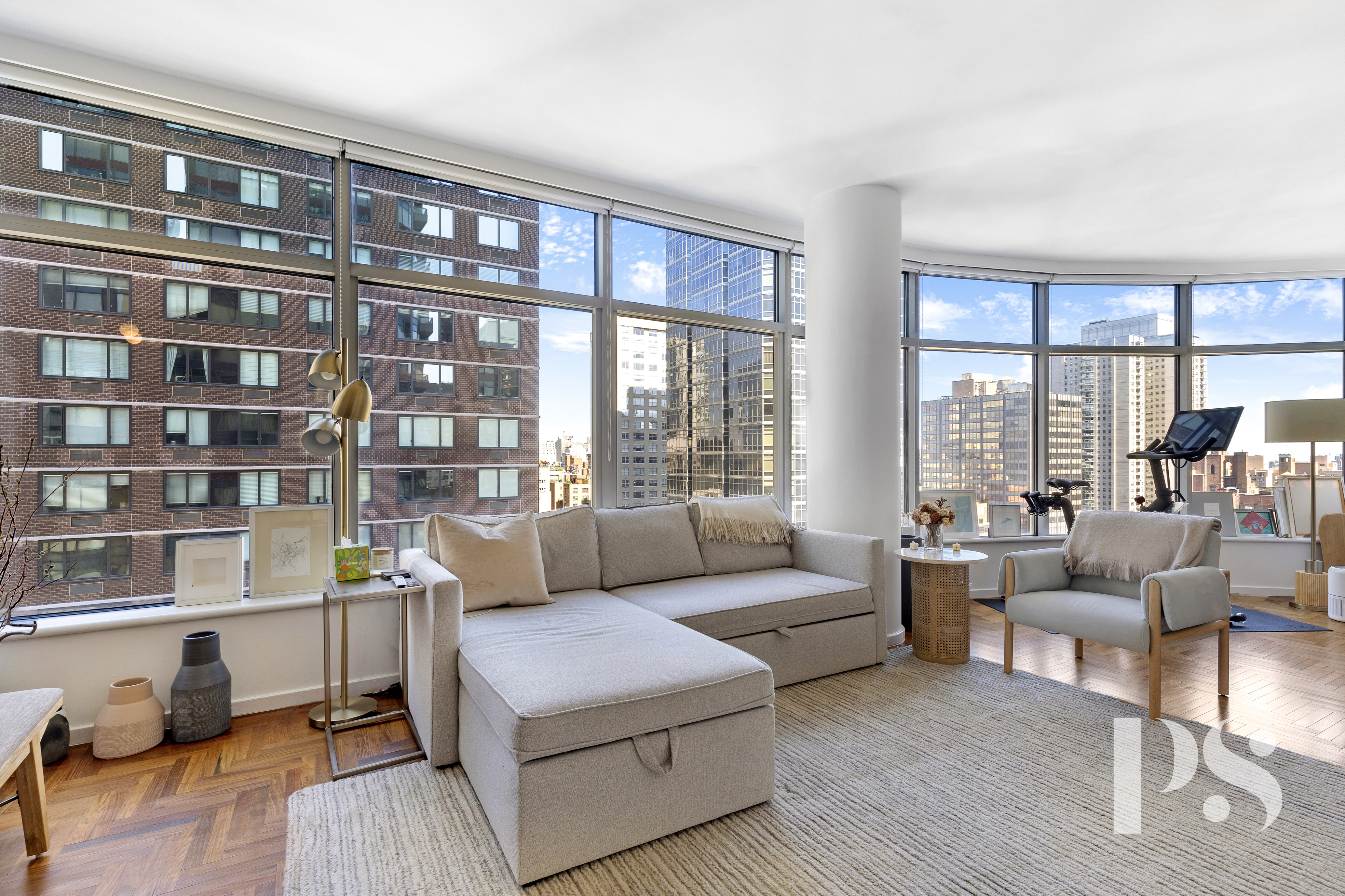 a living room with furniture and a floor to ceiling window next to a large window